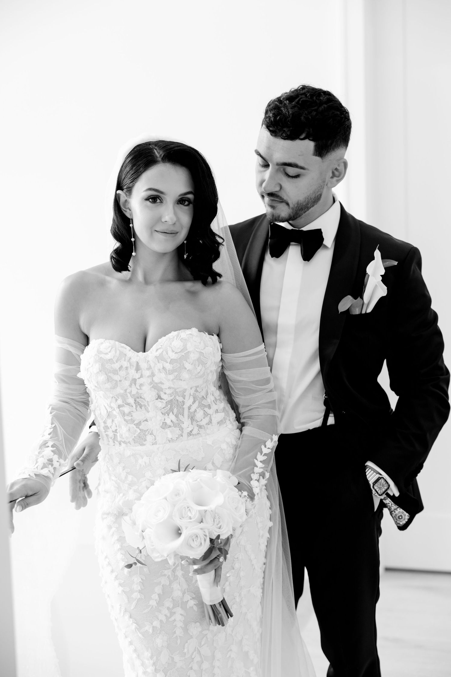 Classic black and white portrait of wedding couple with white rose bouquet.