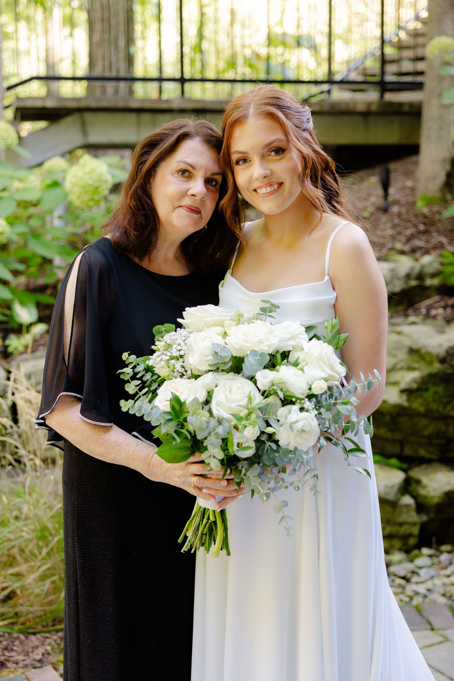 An intimate garden portrait with a stunning white rose bouquet.