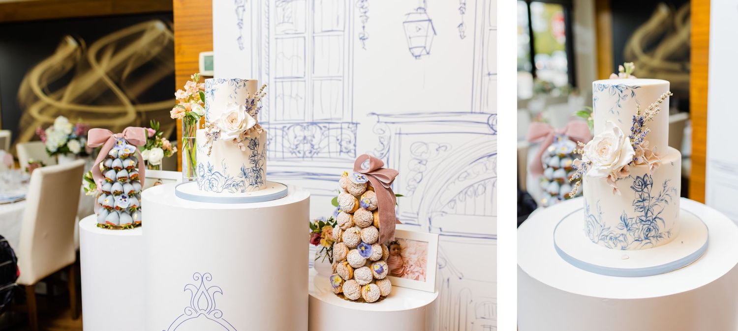 Modern wedding dessert display featuring white pedestals and artistic architectural drawings.