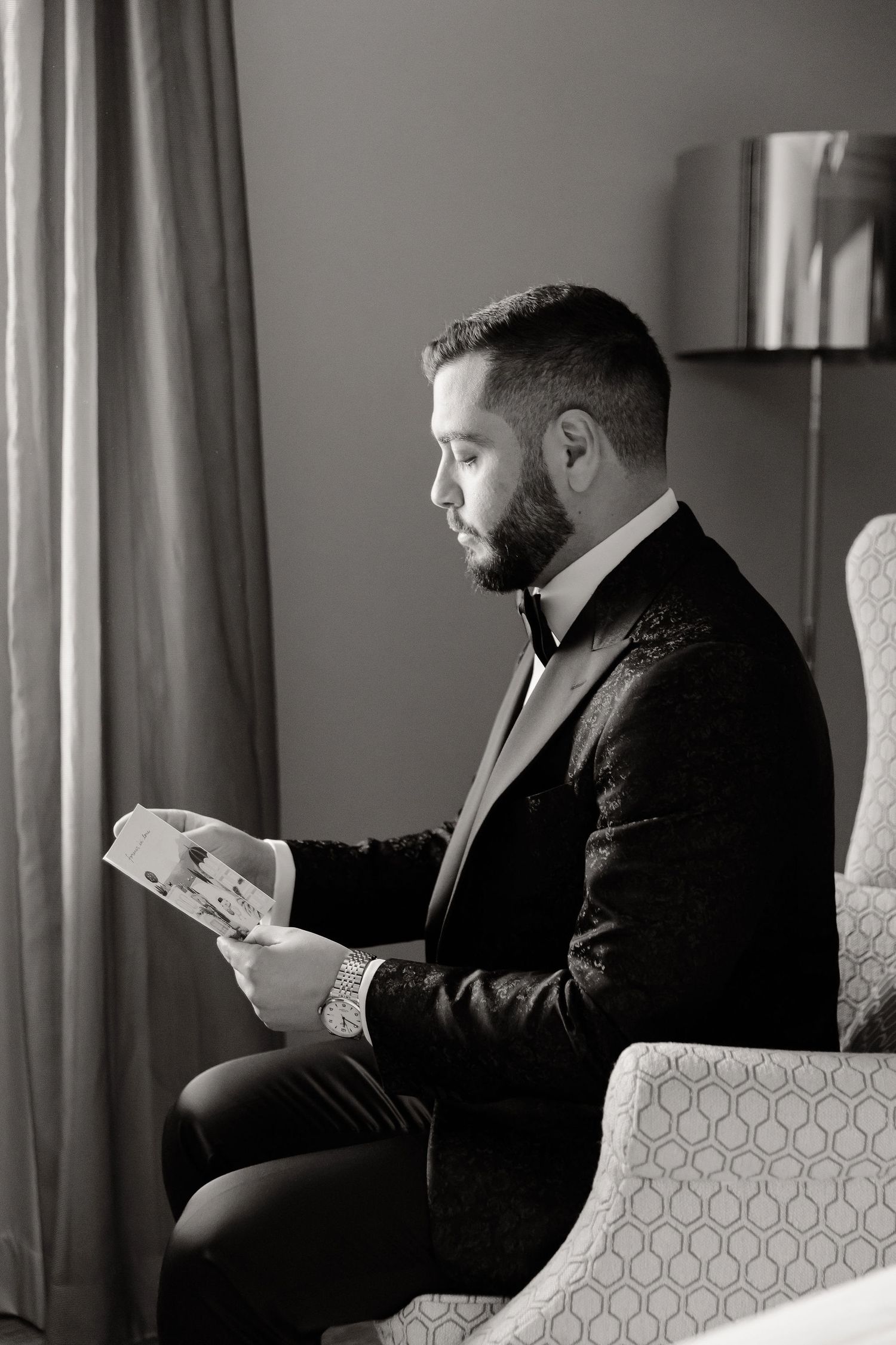 Series of photos showing someone in a black suit sitting on a couch looking at their phone.