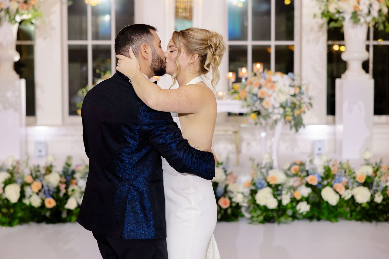 Elegant wedding reception space with romantic floral decor and large windows.