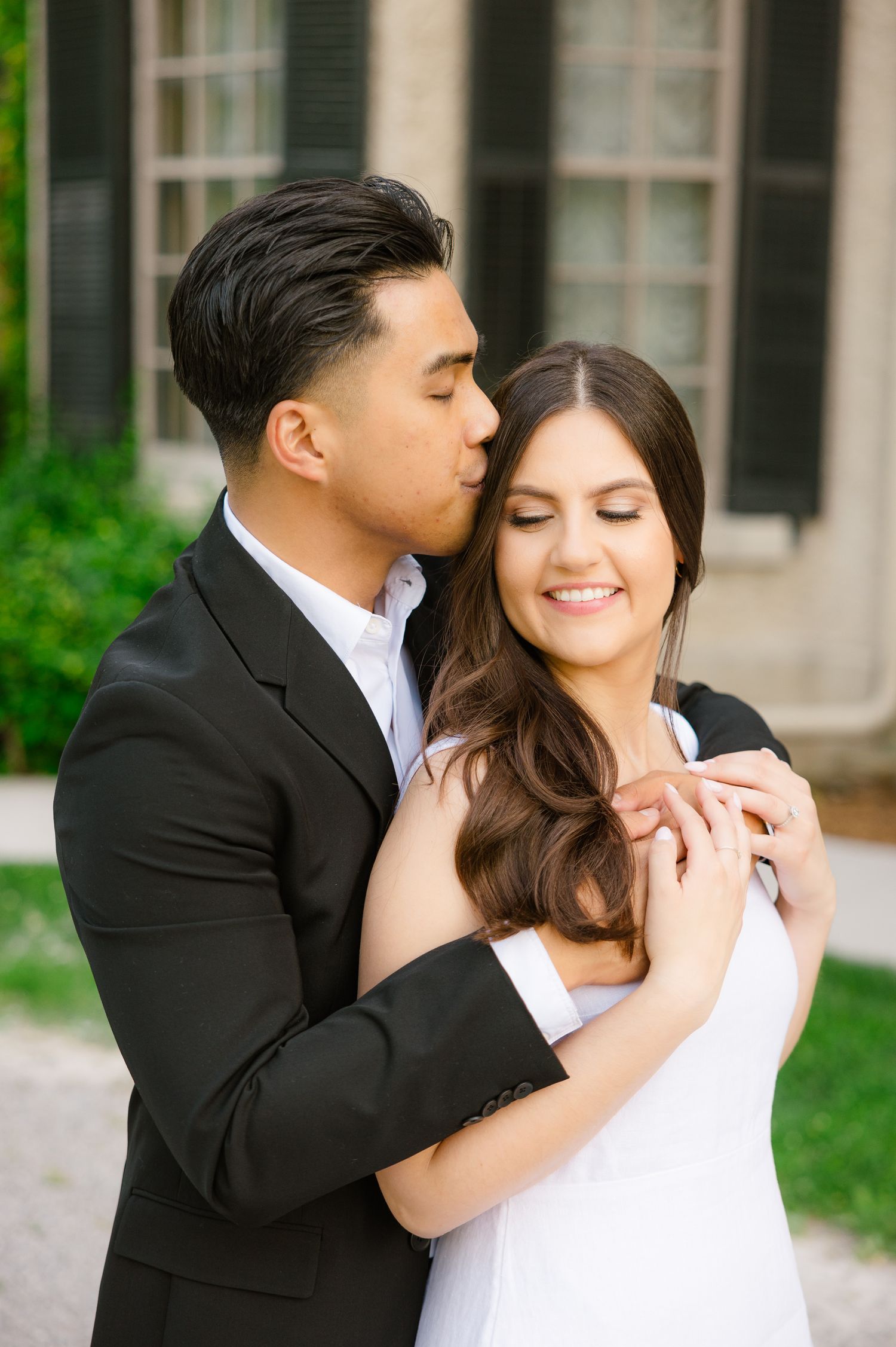 Intimate portrait of couple sharing romantic moment in garden setting.