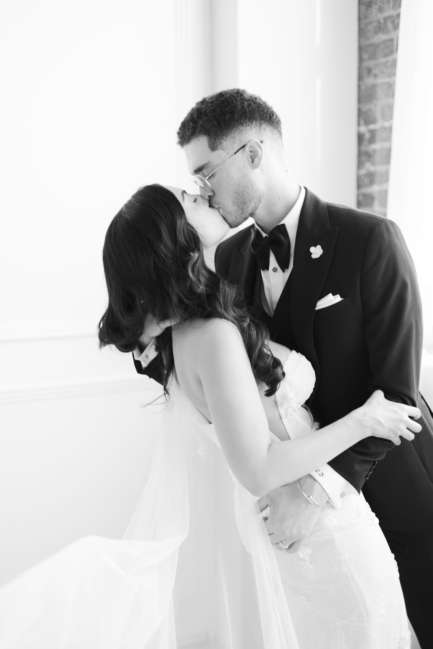 Black and white romantic wedding portrait capturing intimate moment.