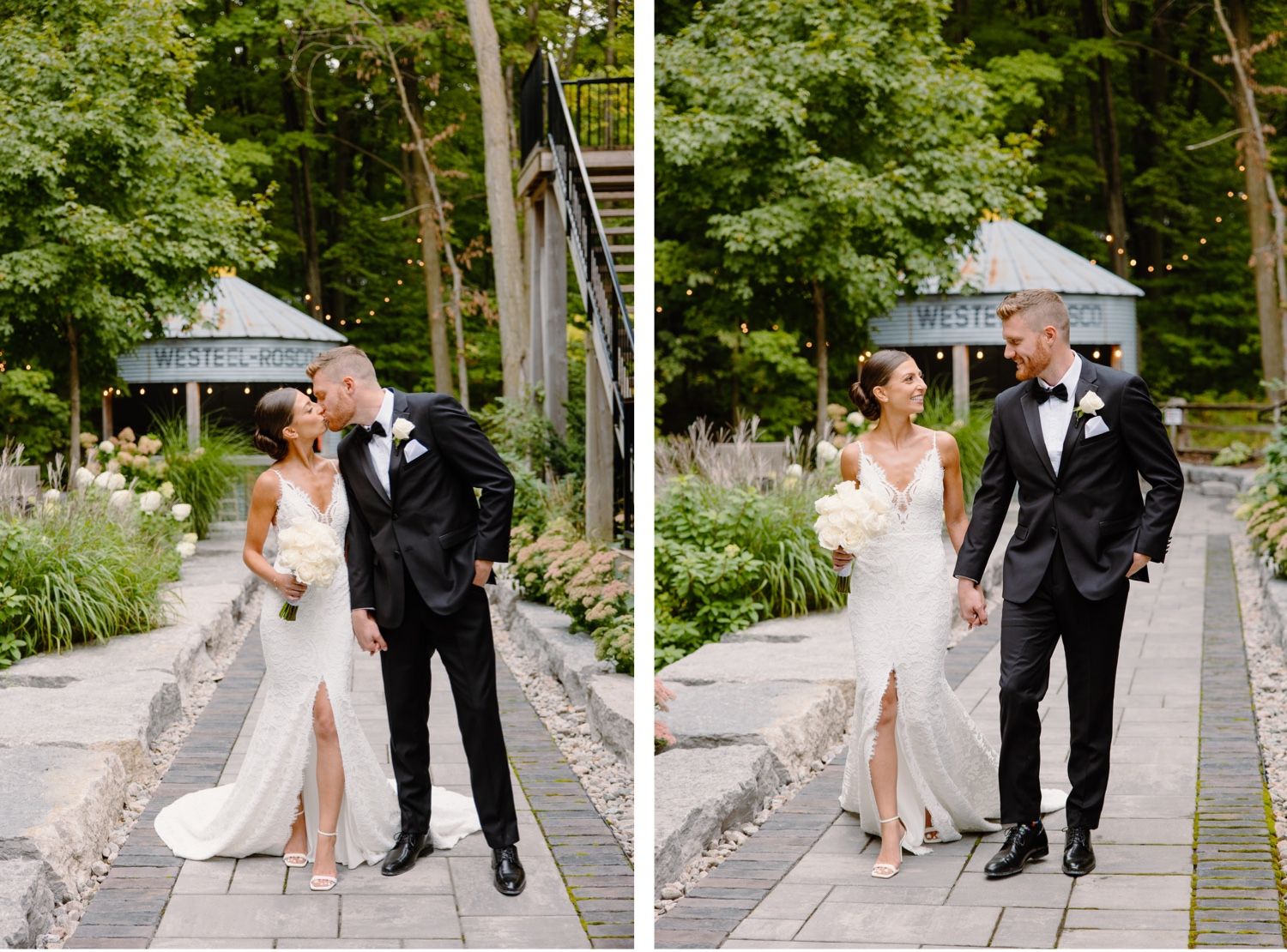 A wedding couple walking together on a stone path surrounded by lush greenery and gardens.