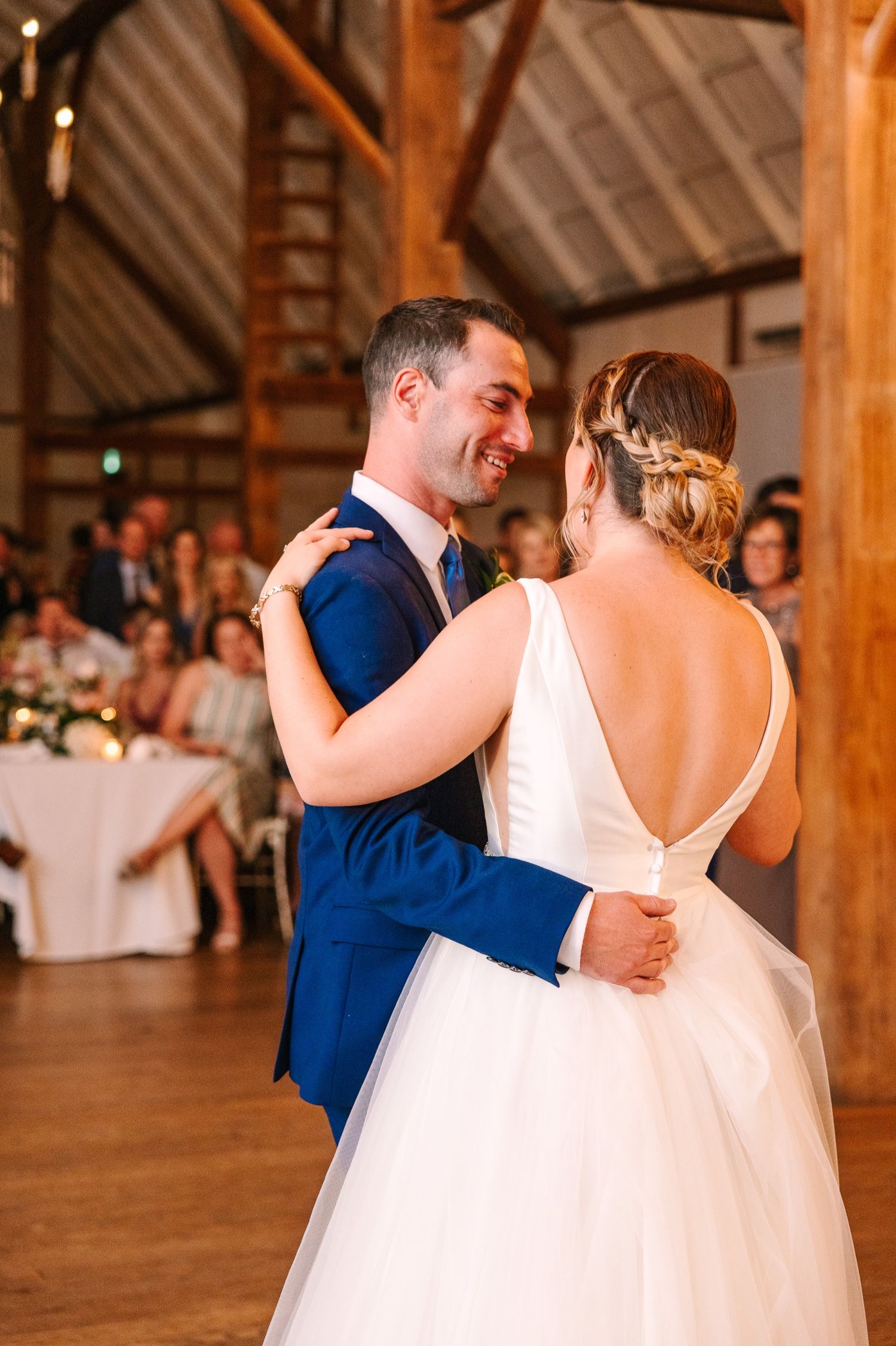 Intimate dancing moment at rustic barn wedding reception.