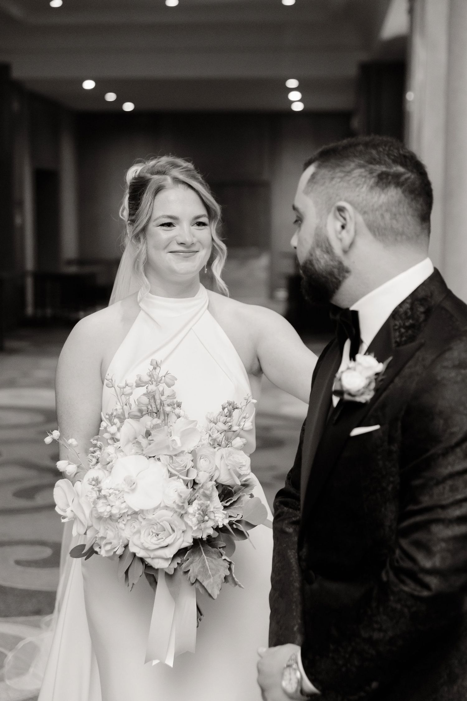 Black and white wedding photos showing intimate moments between couple with elegant floral bouquet.