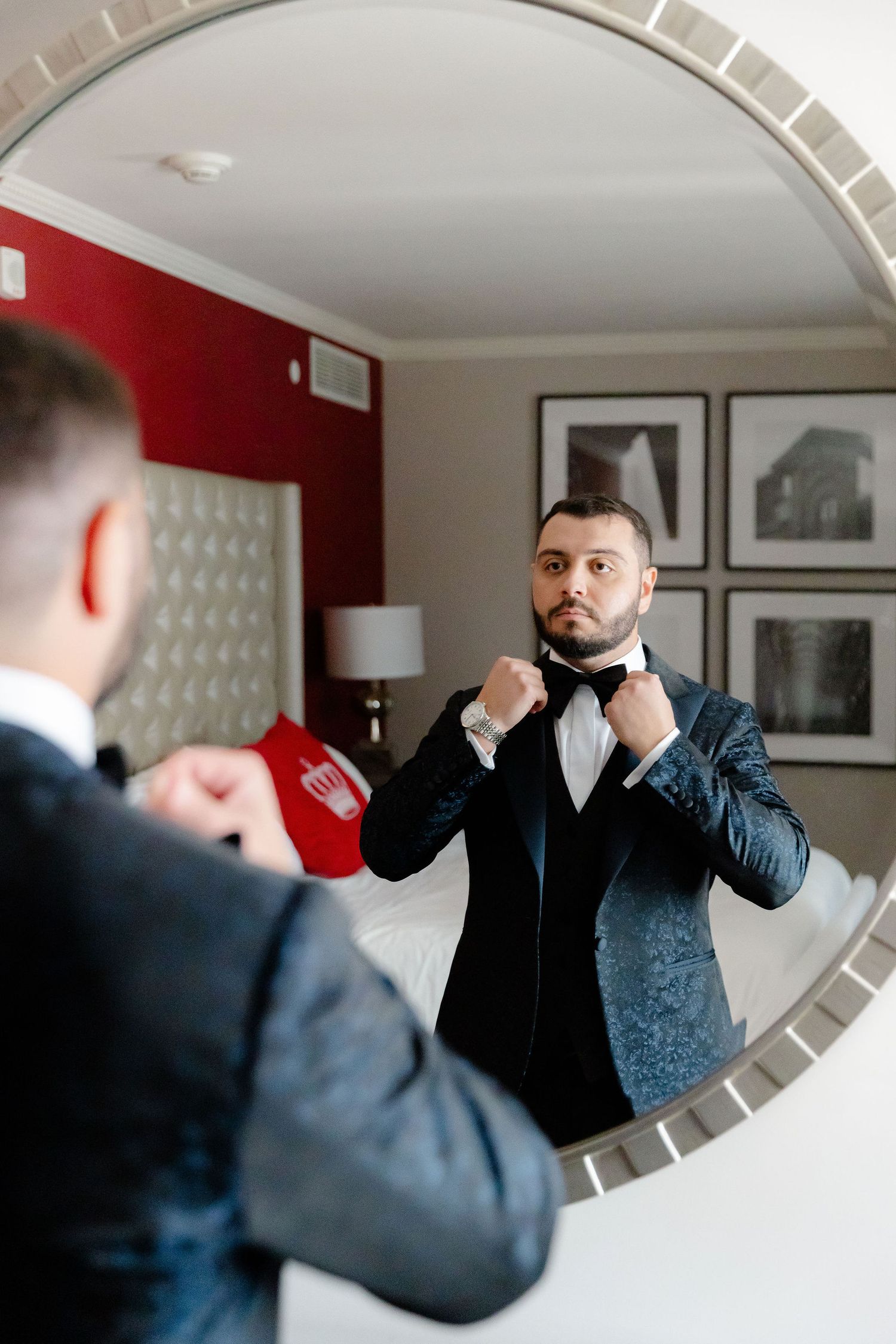 A sequence of mirror reflections shows someone adjusting their tie and getting ready in formal attire.