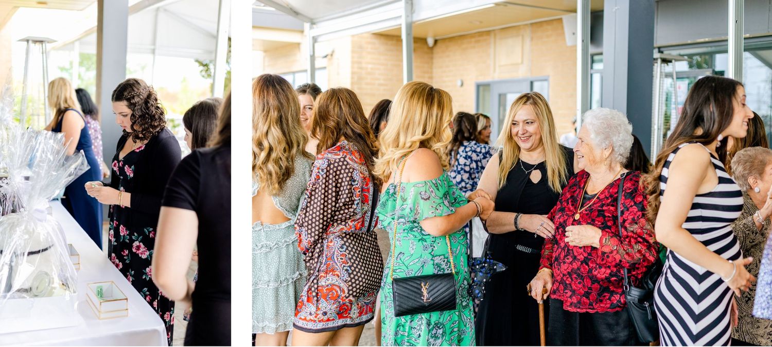 A group mingles at an outdoor reception with white tent draping and natural lighting.