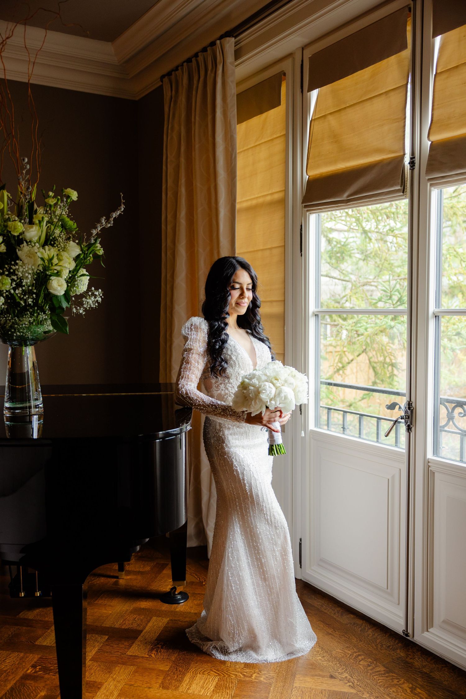 Bridal portrait in vintage room with hardwood floors, piano, and large windows.