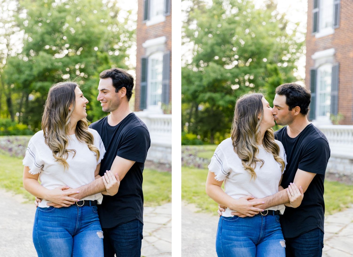 A romantic couple embraces in casual outfits against a backdrop of brick buildings and trees.