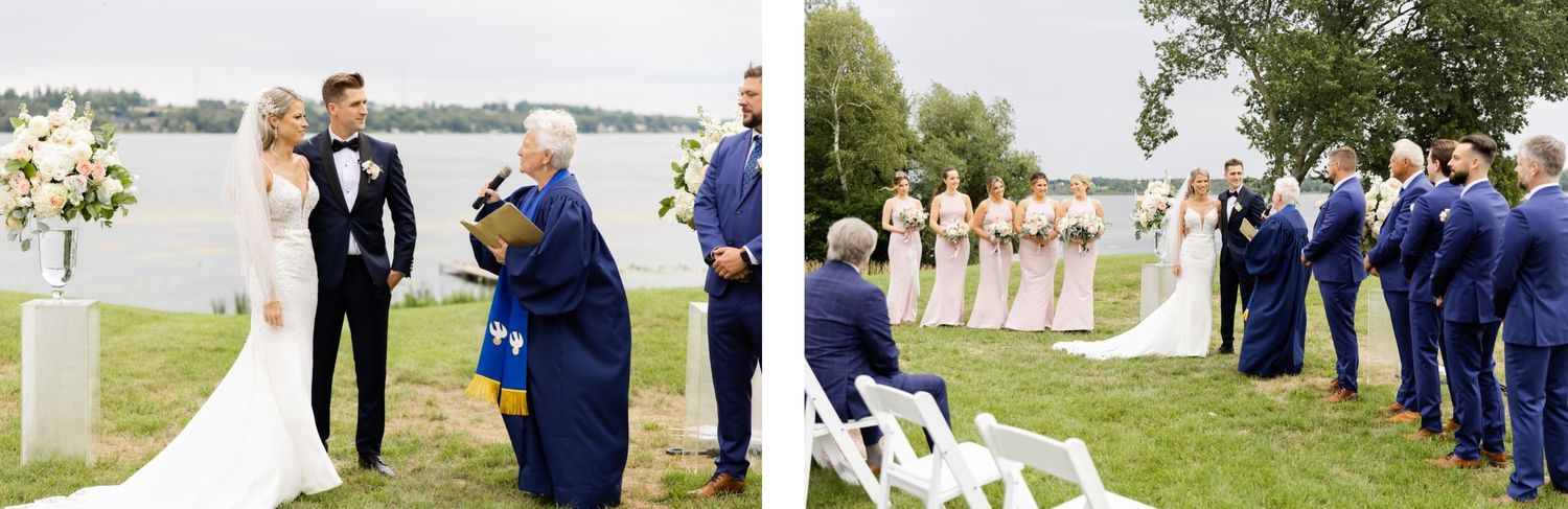 Outdoor wedding ceremony by a lake with wedding party and guests gathered under overcast skies.