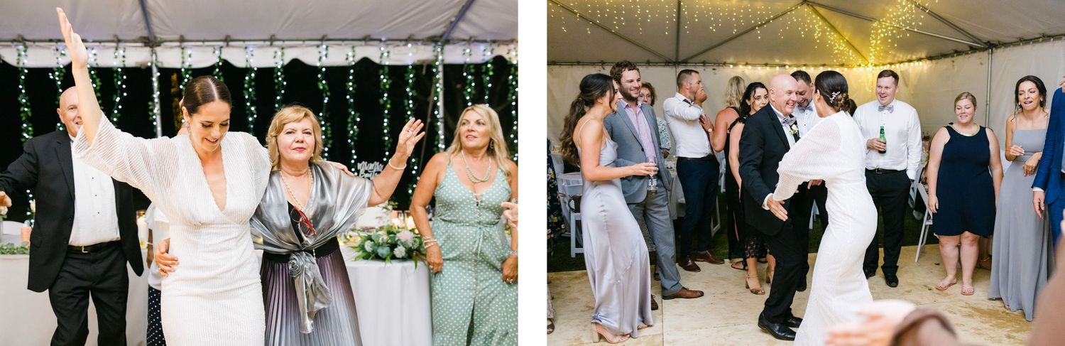 Wedding party guests dancing and celebrating in a festive tent setting.