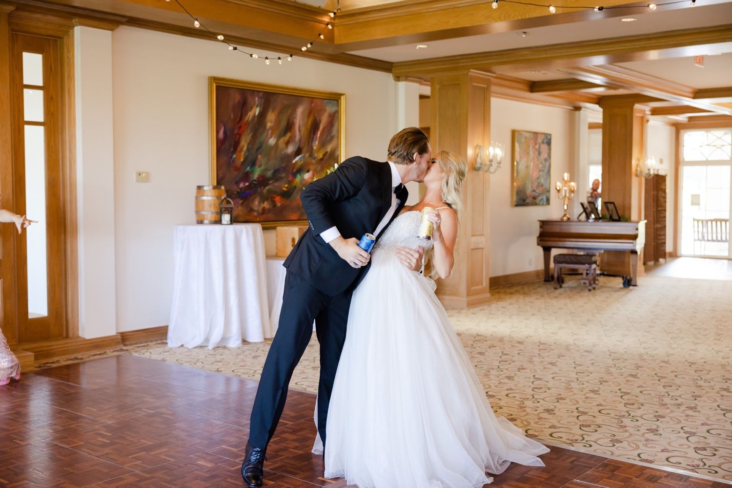 Romantic dance moment in a luxurious ballroom with wooden details and classic decor.