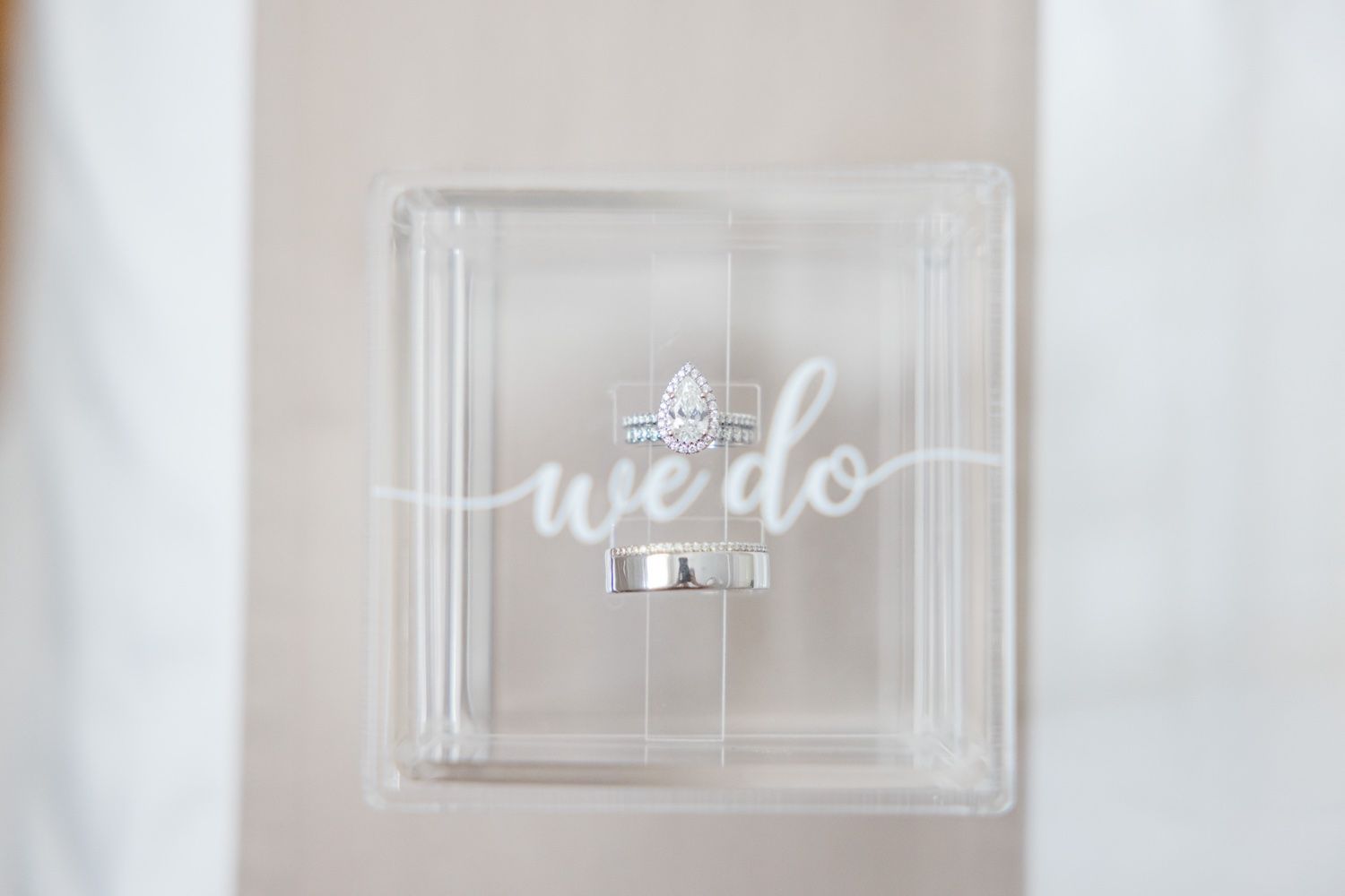 Clear acrylic box with 'we do' written in white script lettering against a light background.