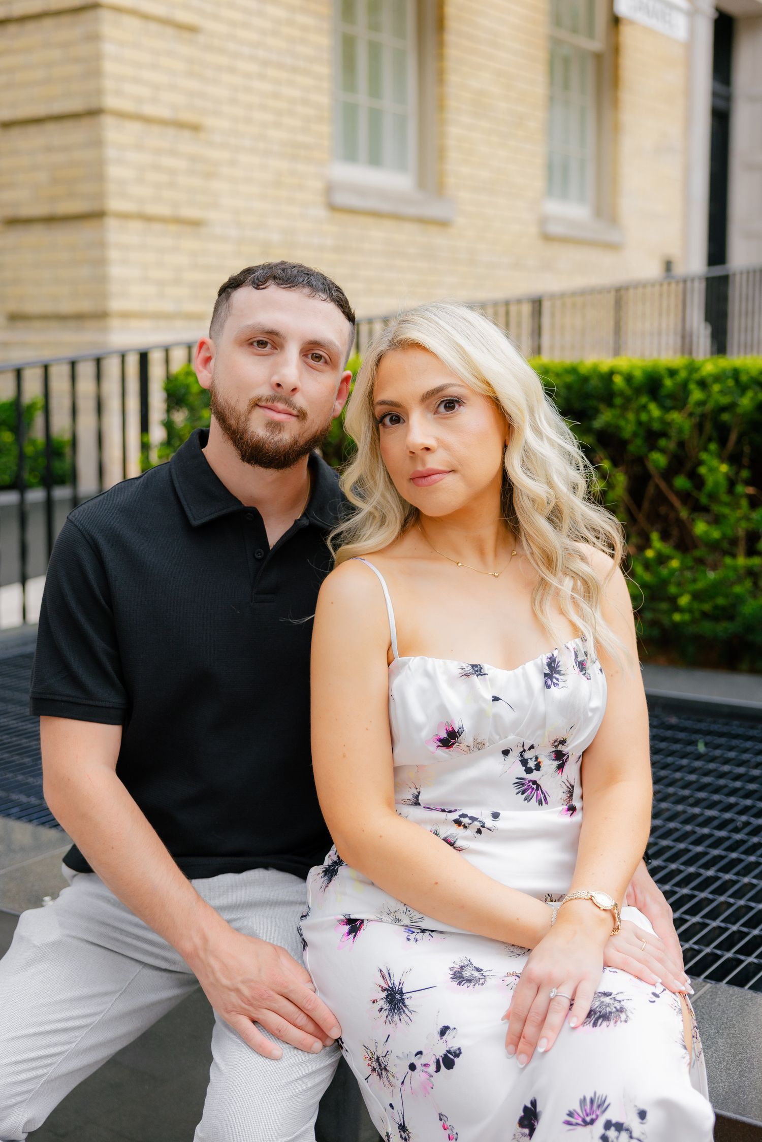 A romantic outdoor portrait of a couple in coordinated casual attire.