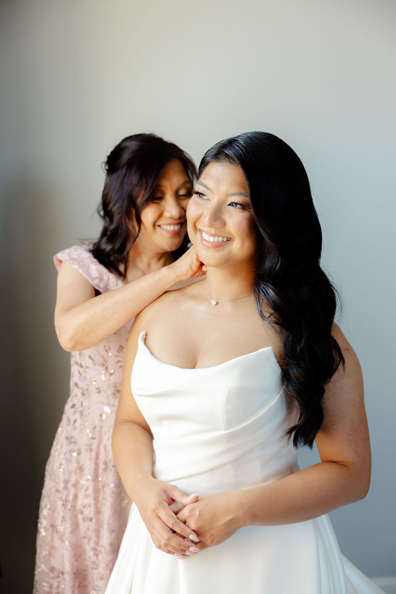 A candid portrait capturing pure joy and connection during wedding day preparations.