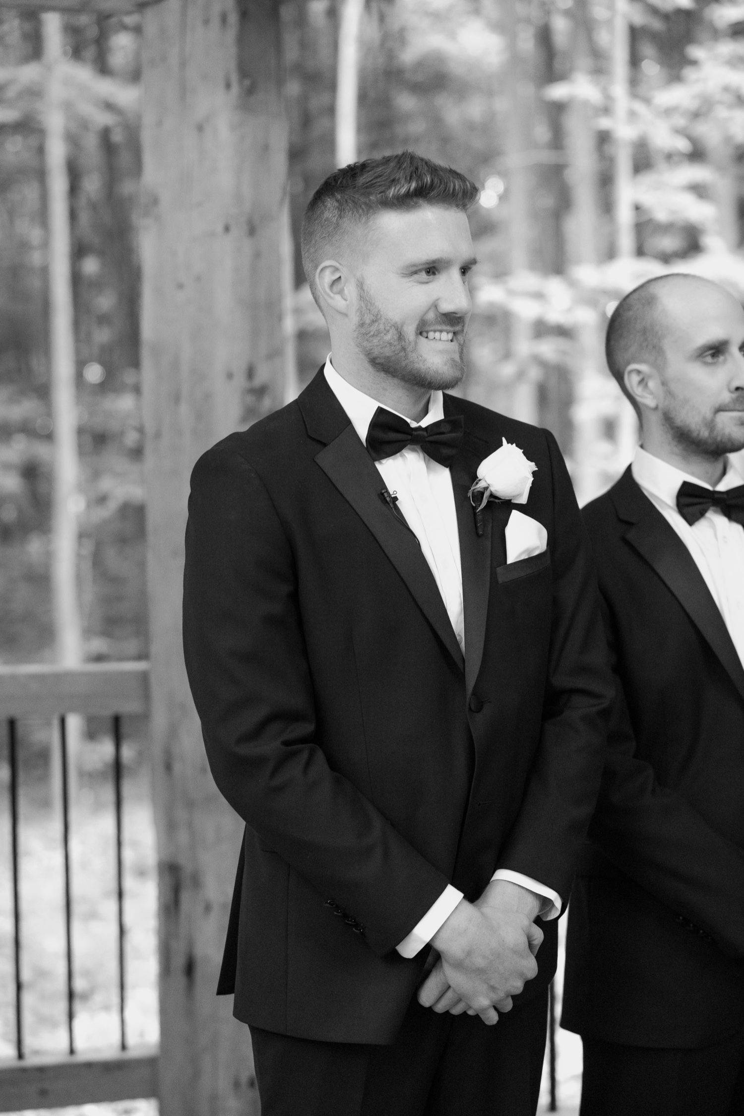 Classic black and white portrait at rustic outdoor wedding venue.