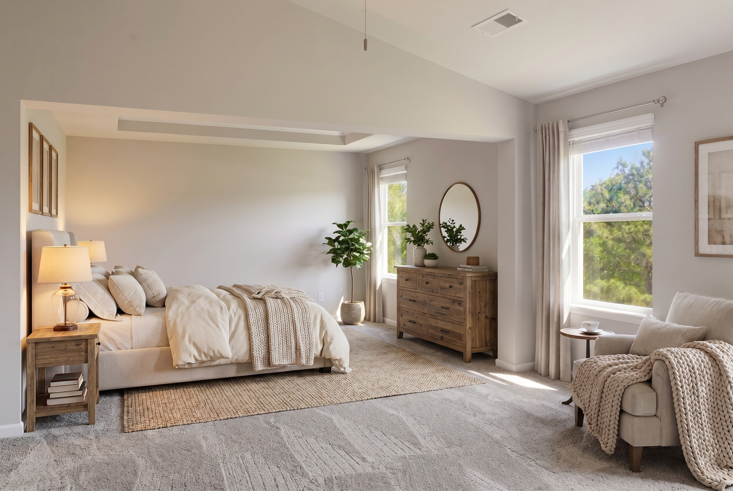 Spacious master bedroom with vaulted ceiling, large windows, and neutral toned furnishings on plush carpet.