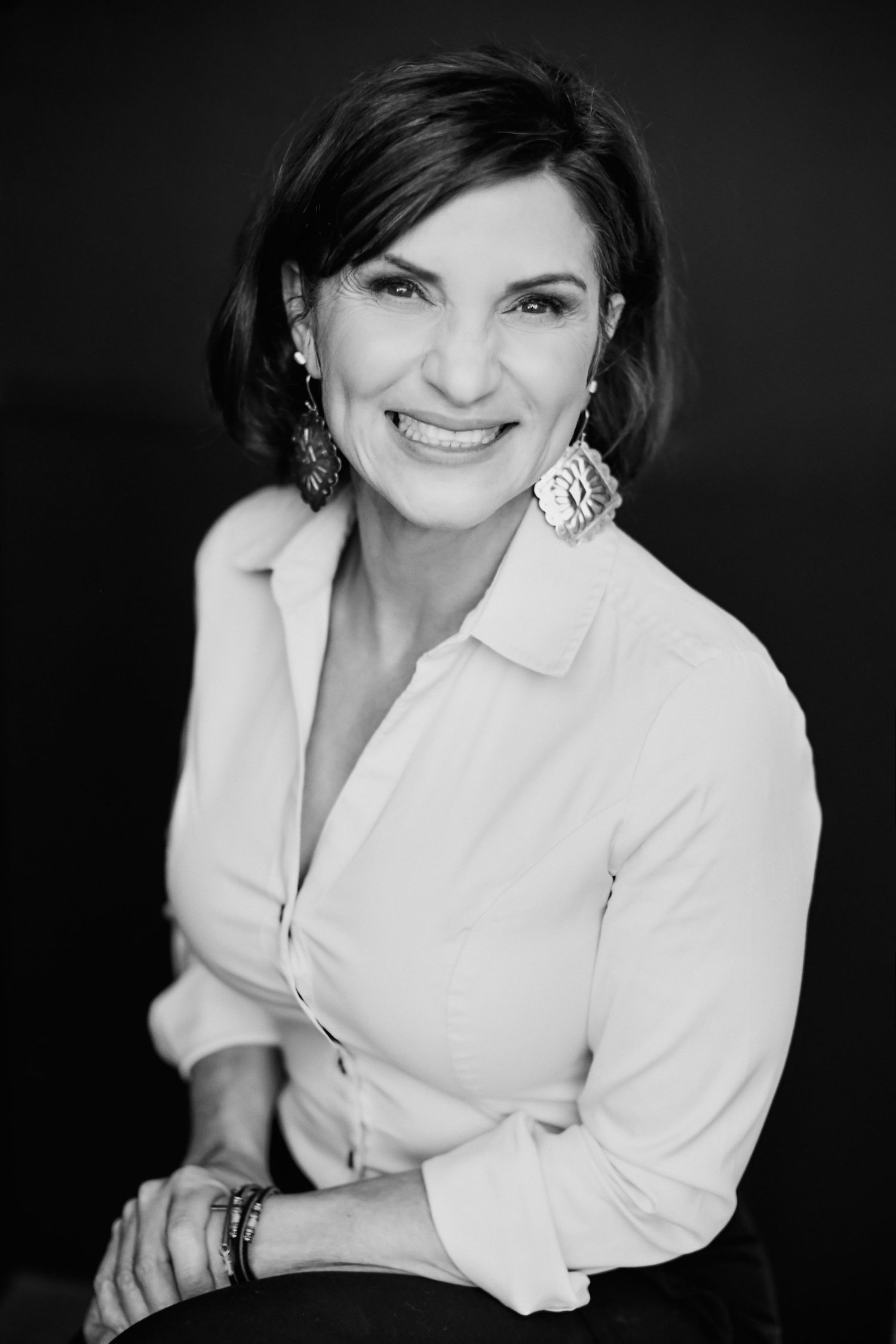 Professional black and white portrait series showing different poses in a white blouse.