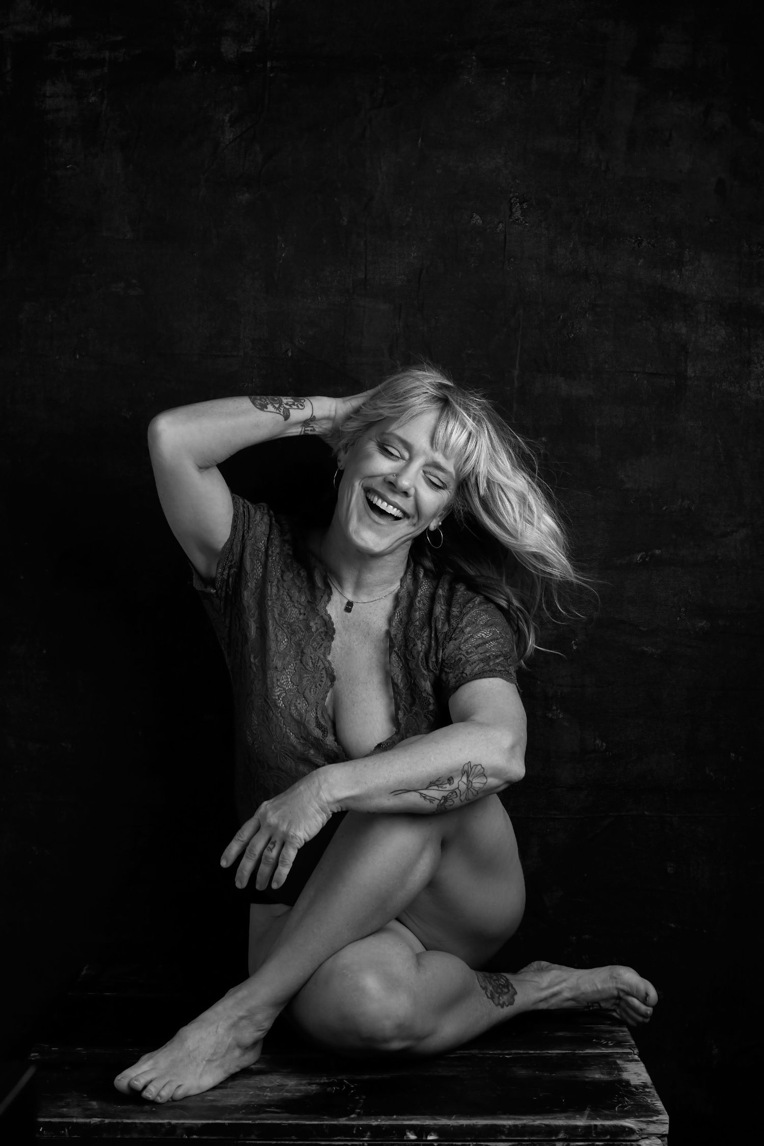 Artistic black and white portrait series showing expressive poses on dark background.