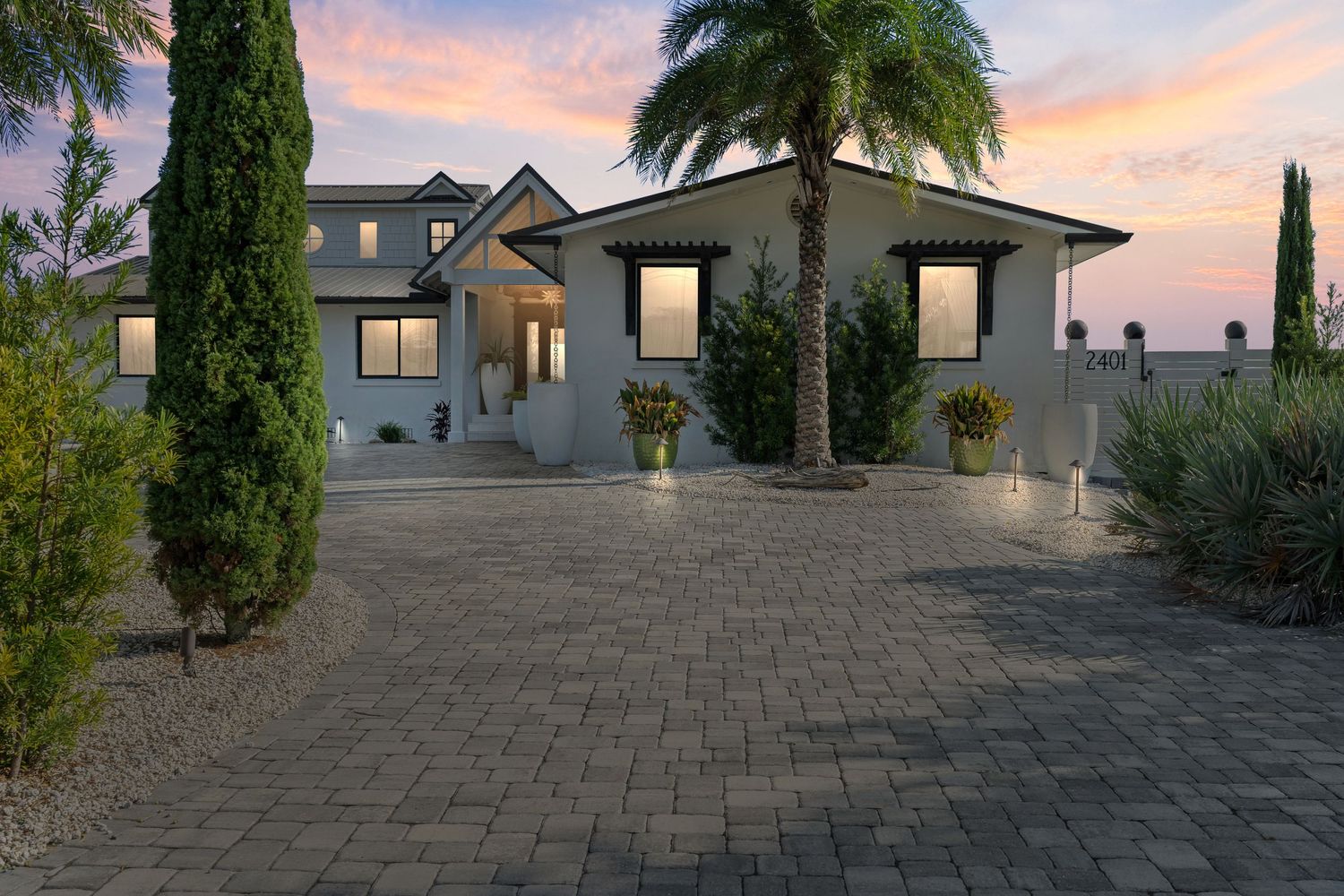 Twilight skies highlight gorgeous home with lovely landscaping.