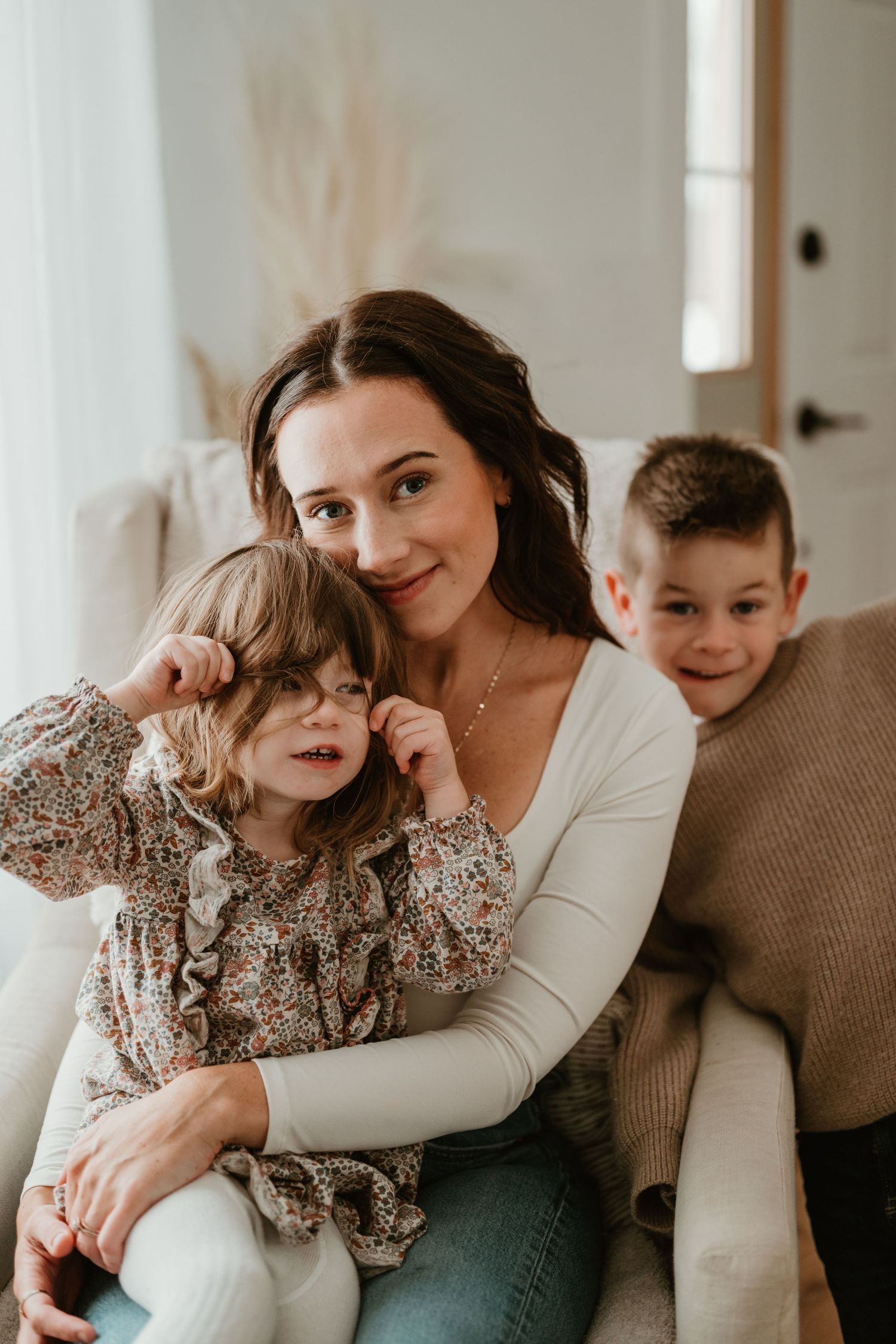 A series of tender family moments captured in four connected photos showing affectionate poses and embraces.