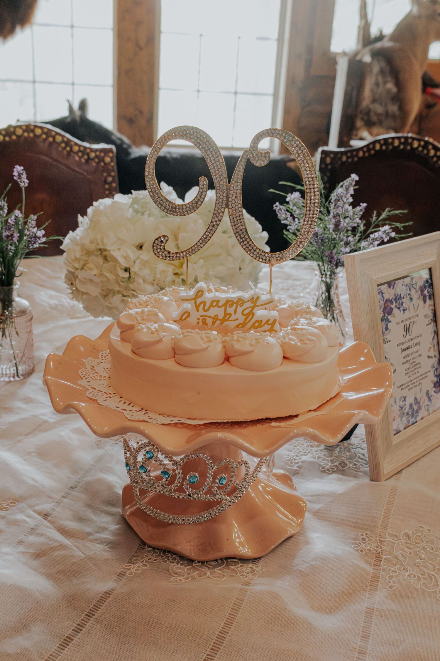 Elegant peach-colored table decor with ornate crown centerpieces and floral accents at a wedding reception.