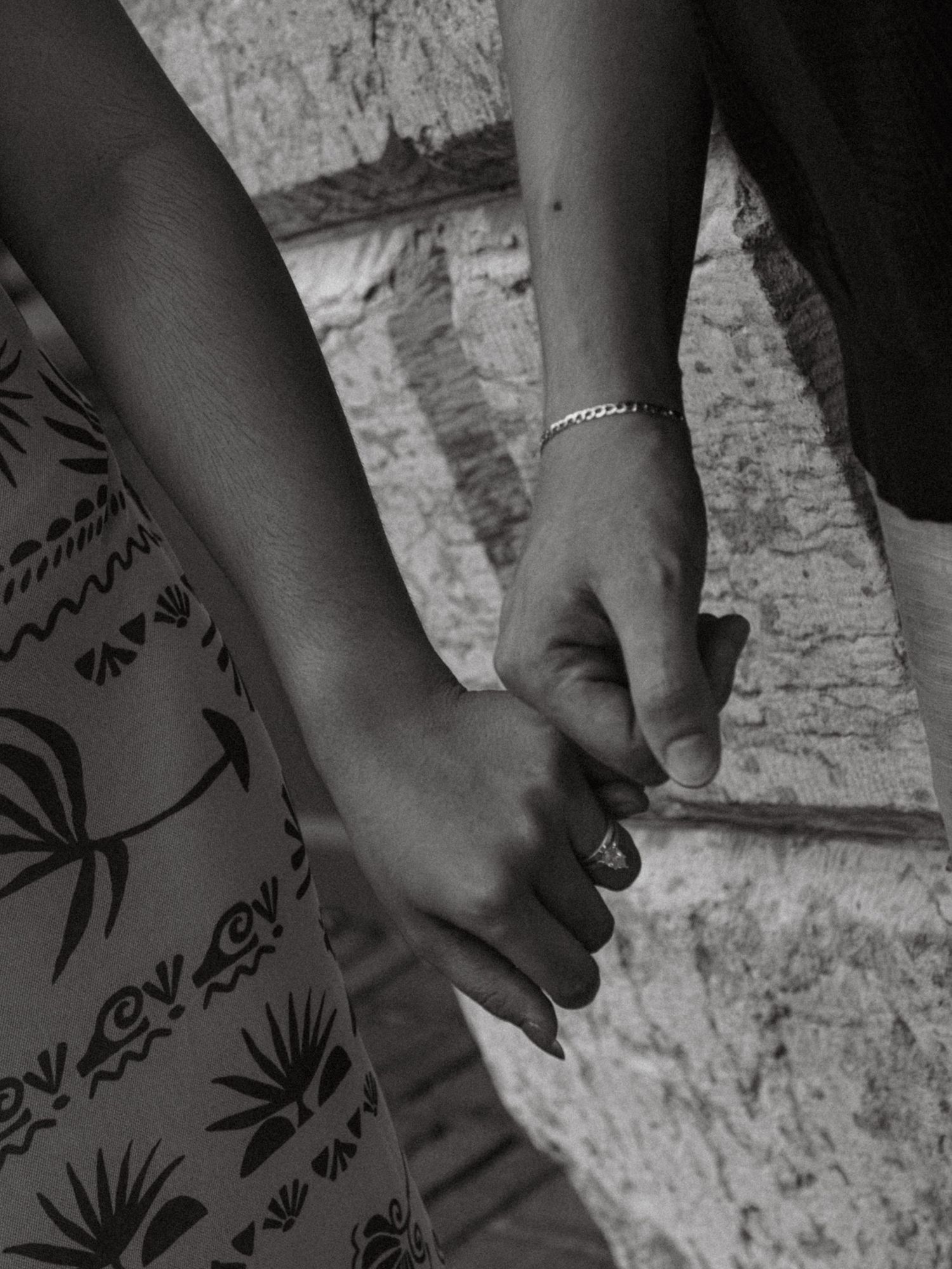 Black and white close-up of decorative tattoos on skin.
