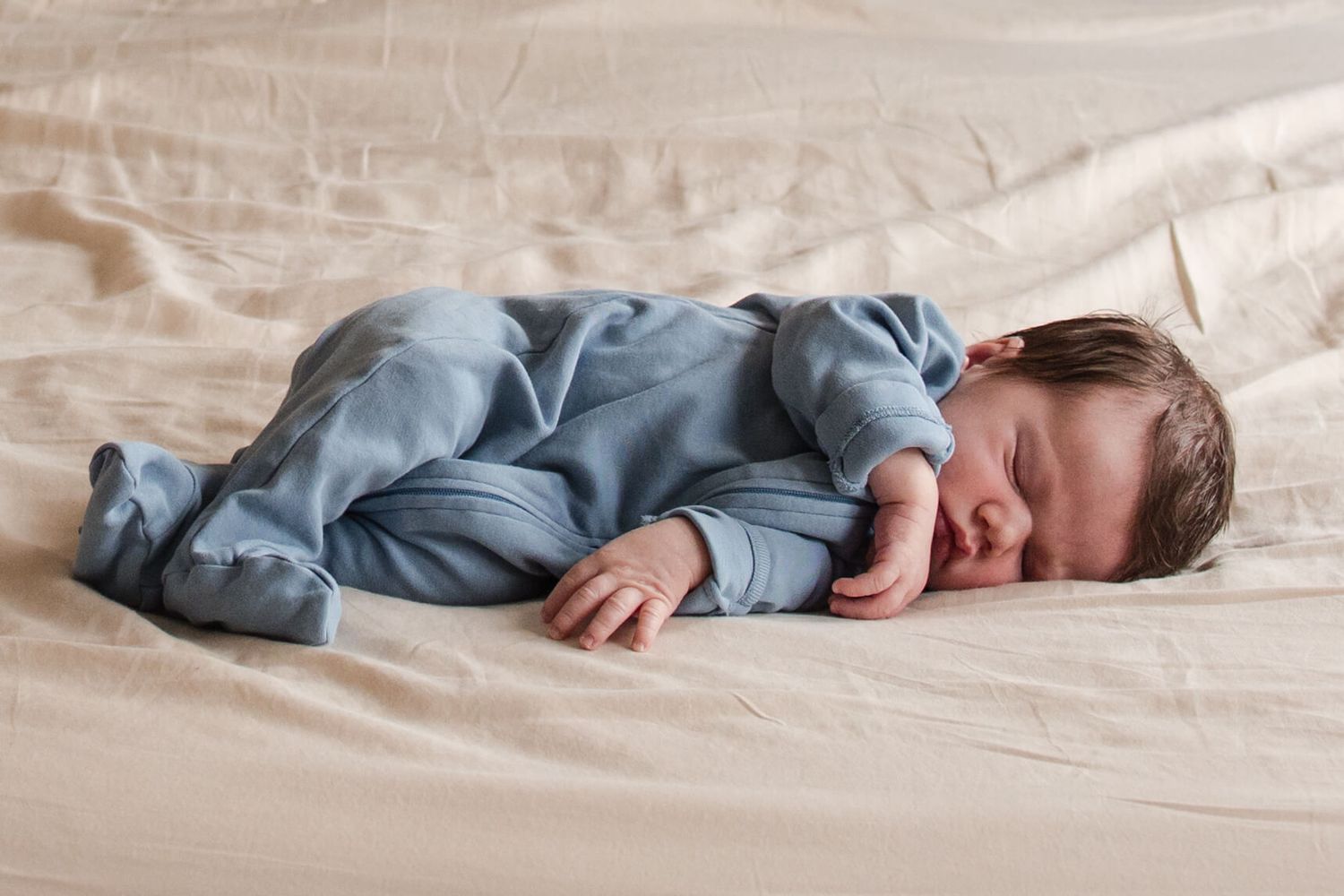 Sleeping newborn photographed naturally at home during a Toronto lifestyle newborn session.