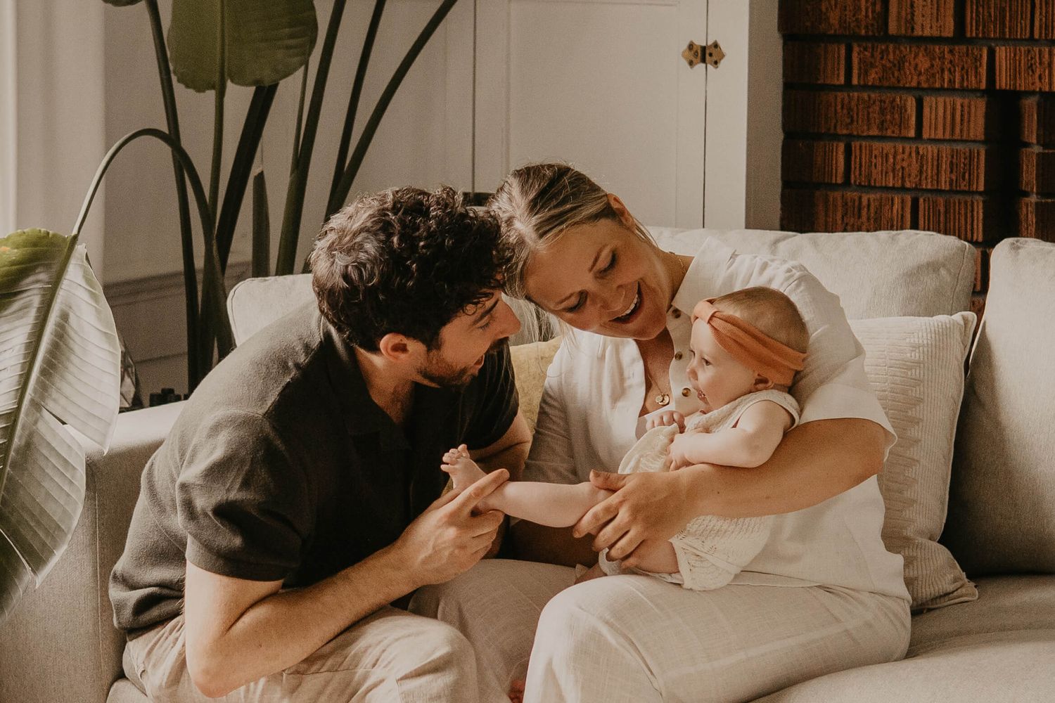 Mother and father cuddling their newborn during a relaxed lifestyle newborn session in Toronto.