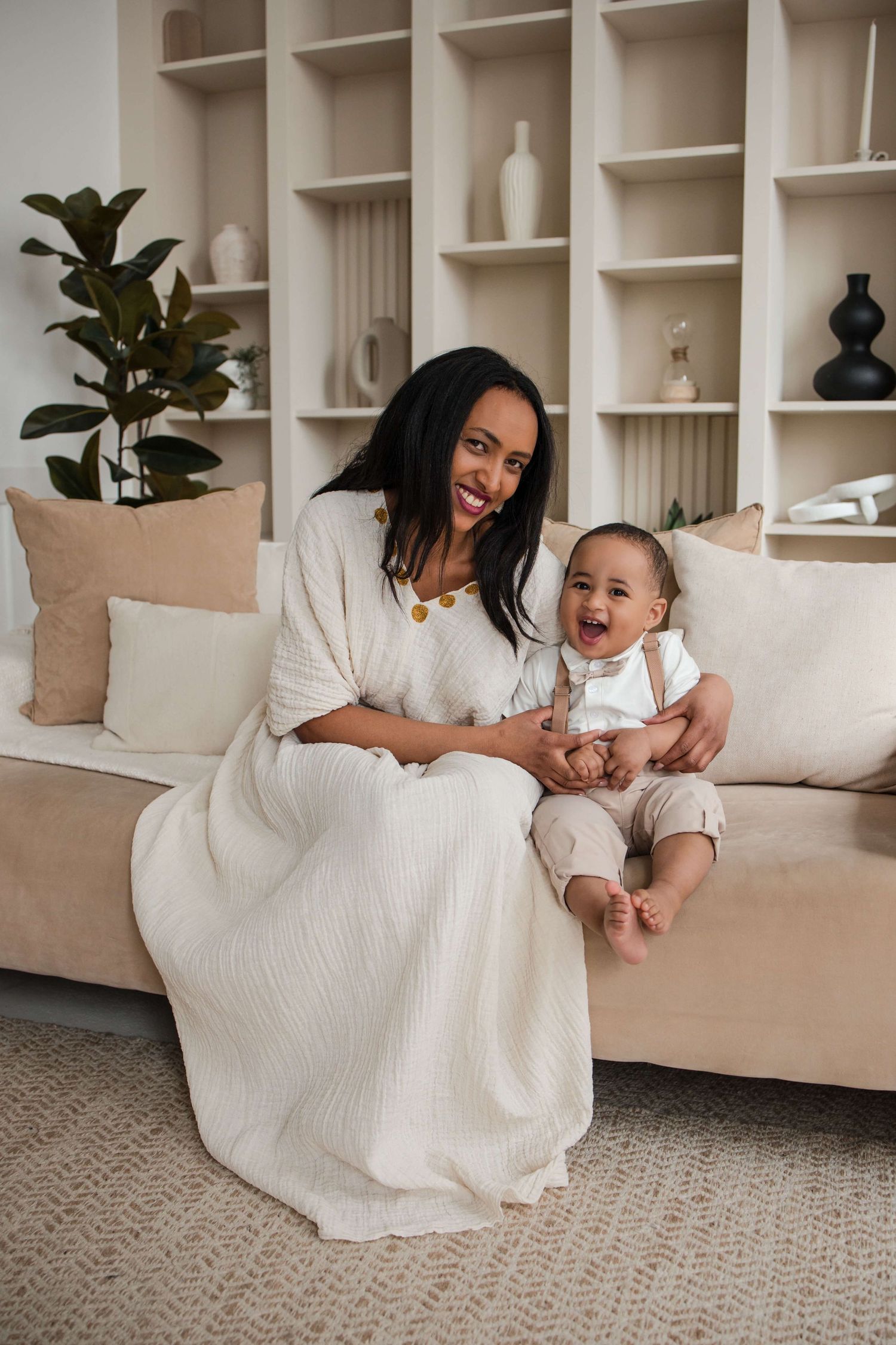 Mother and one-year-old sharing smiles during a lifestyle family session at Mint Room Studios in Toronto with timeless neutral styling.