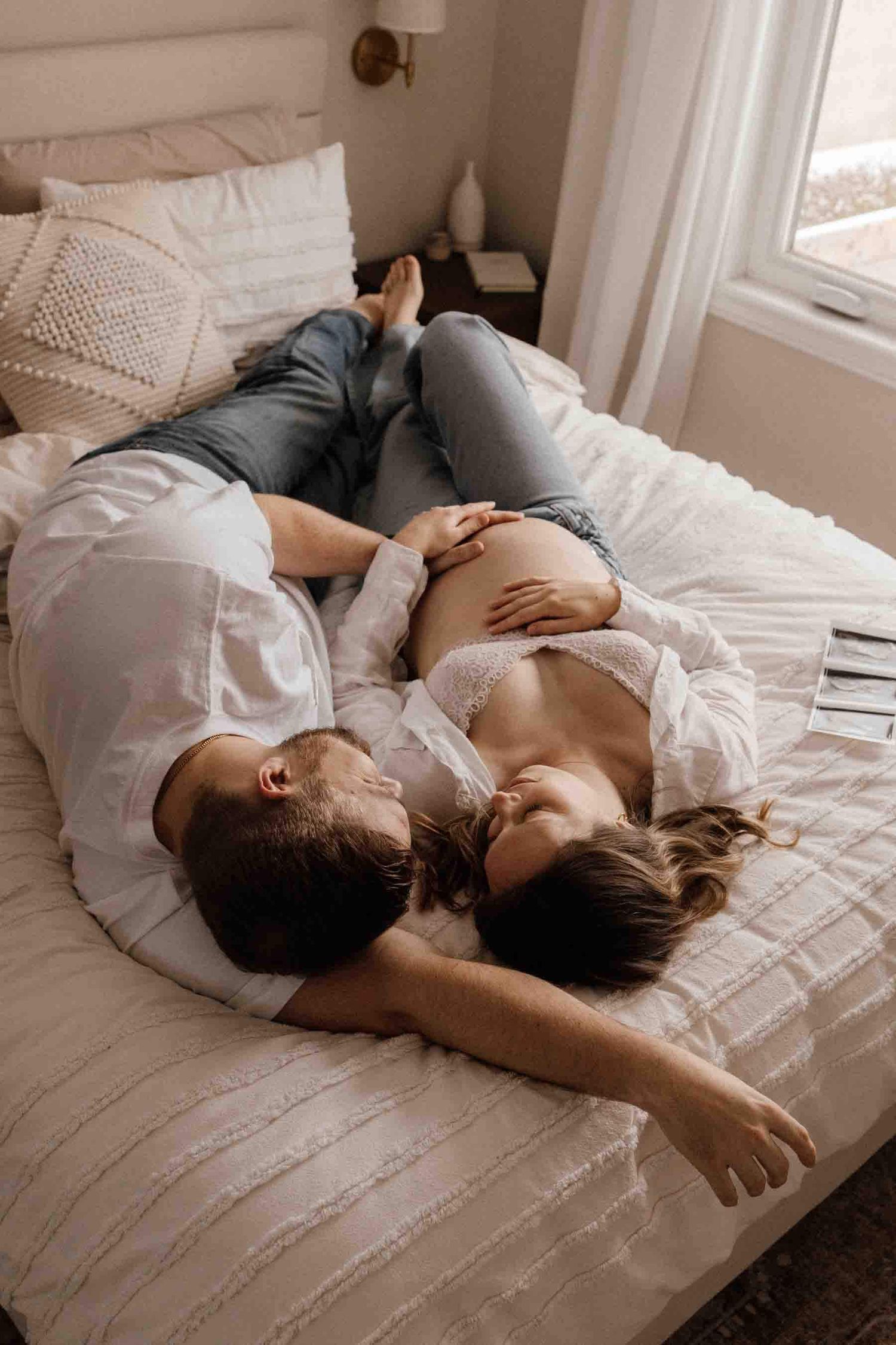Expectant parents sharing a quiet moment together during an in-home maternity photography session in Toronto, celebrating anticipation.