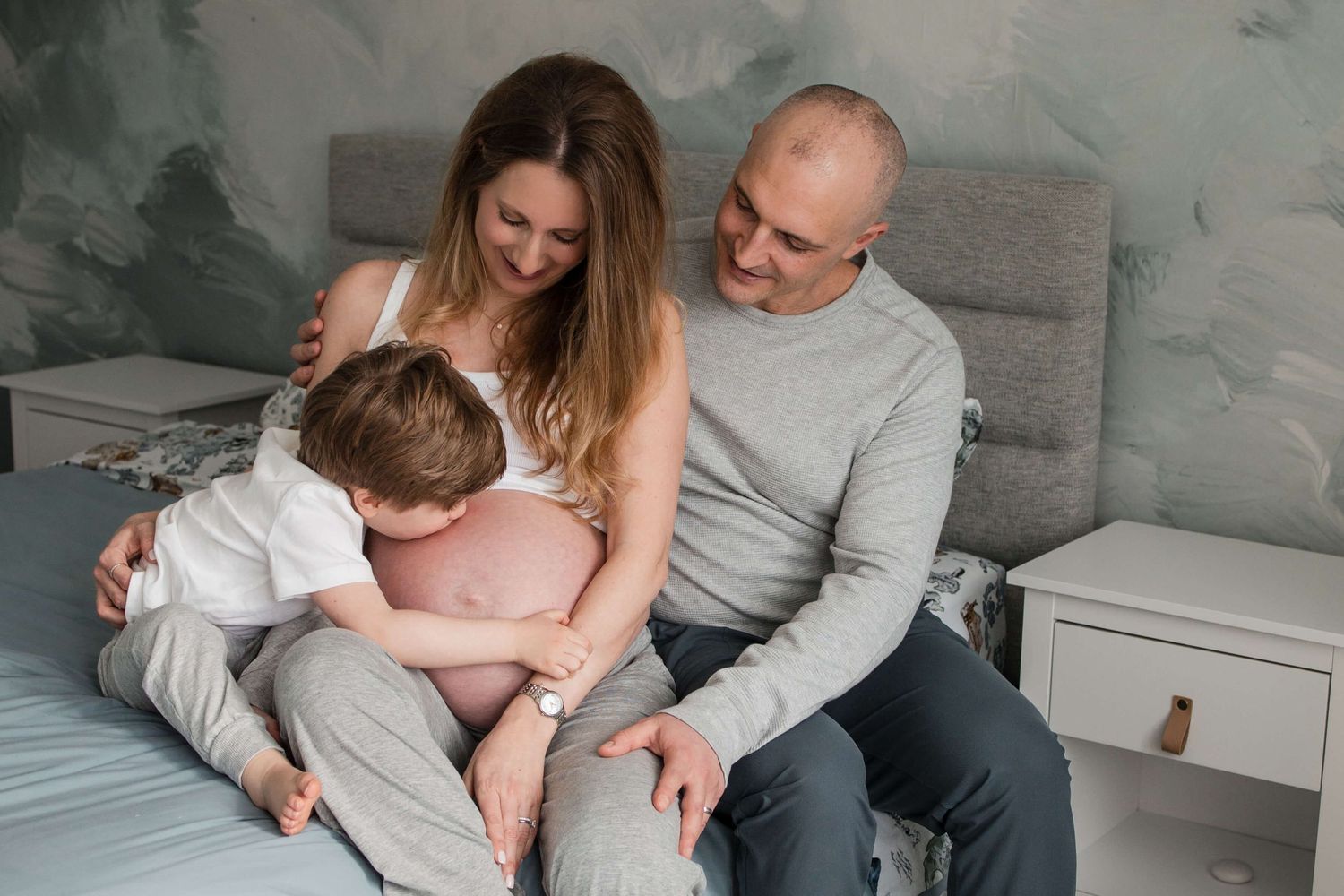 Family expecting a new baby during an in-home maternity photography session in Toronto, capturing love, connection, and anticipation.