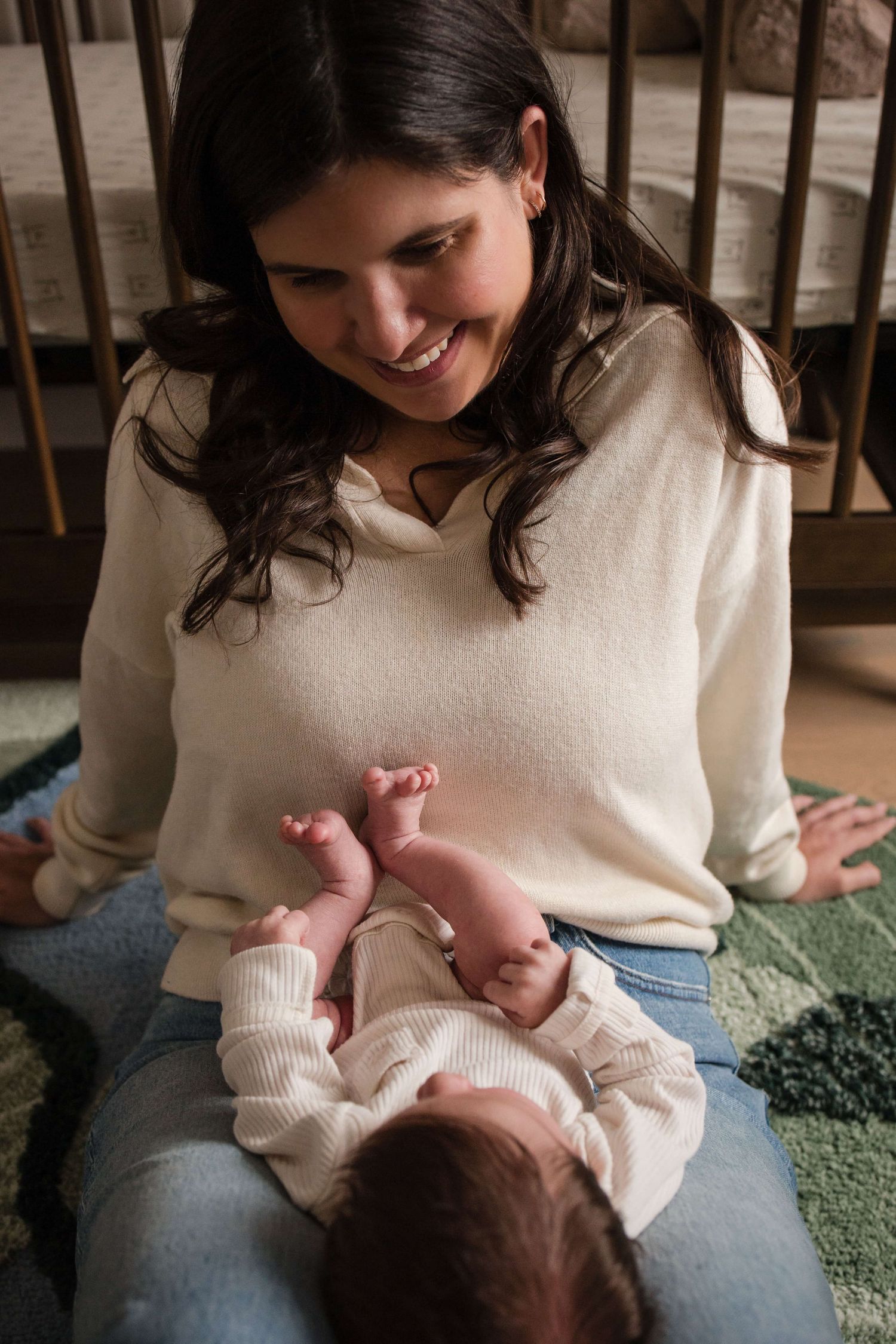 Loving mother admiring her newborn during a natural lifestyle newborn photography session in Toronto.