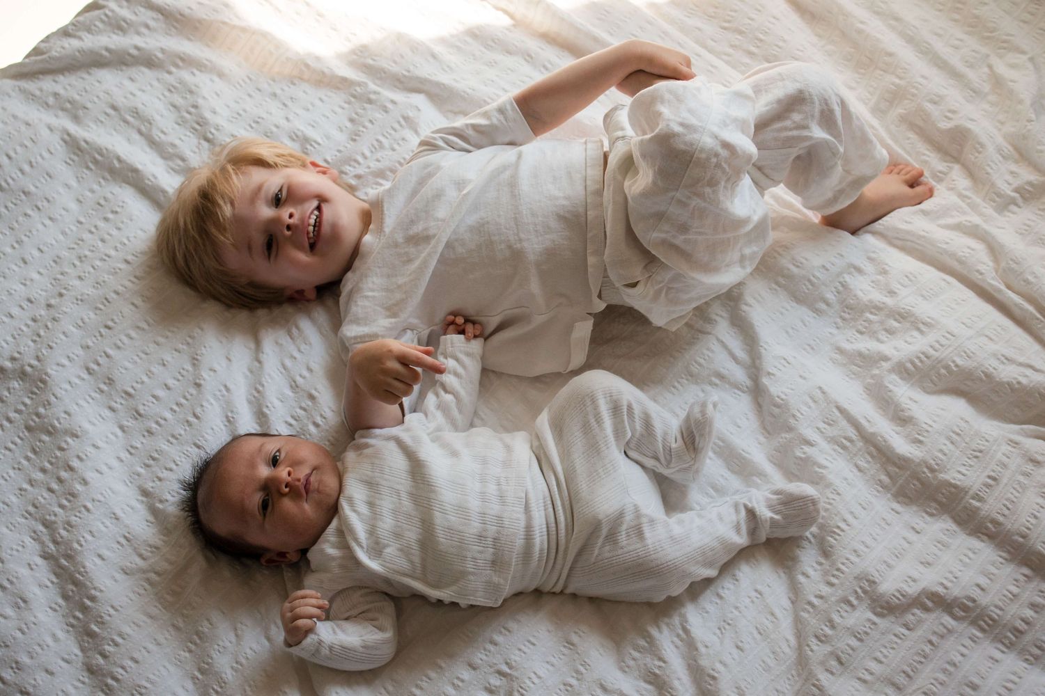 Sweet sibling bond captured during a lifestyle newborn photography session in Toronto.