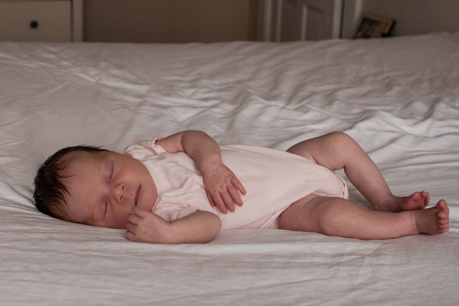Sleeping newborn baby during an in-home newborn photography session in Toronto, capturing tiny details, peace, and new beginnings.