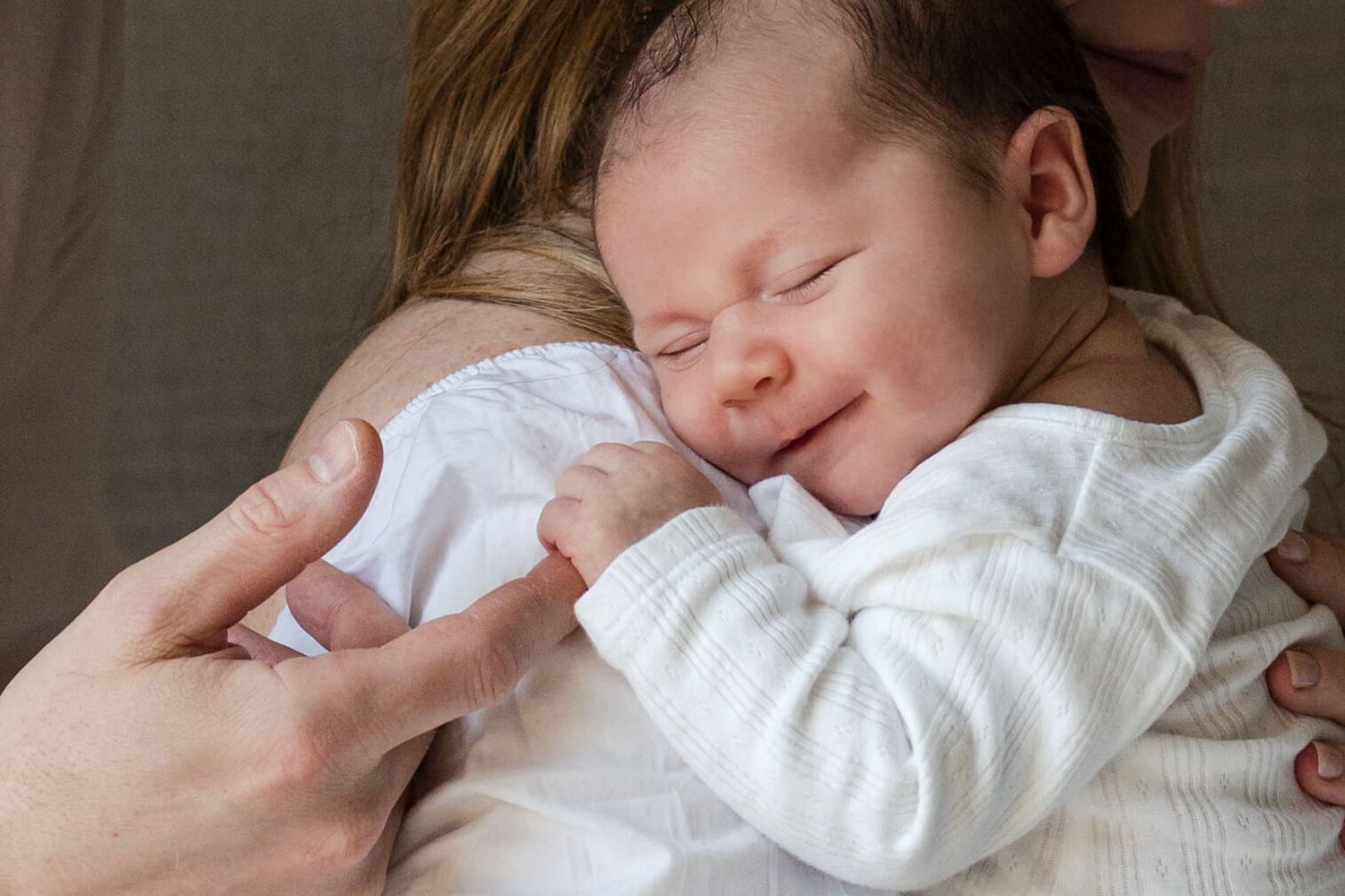 Peaceful newborn resting on mother's shoulder during a lifestyle newborn photography session in Toronto.