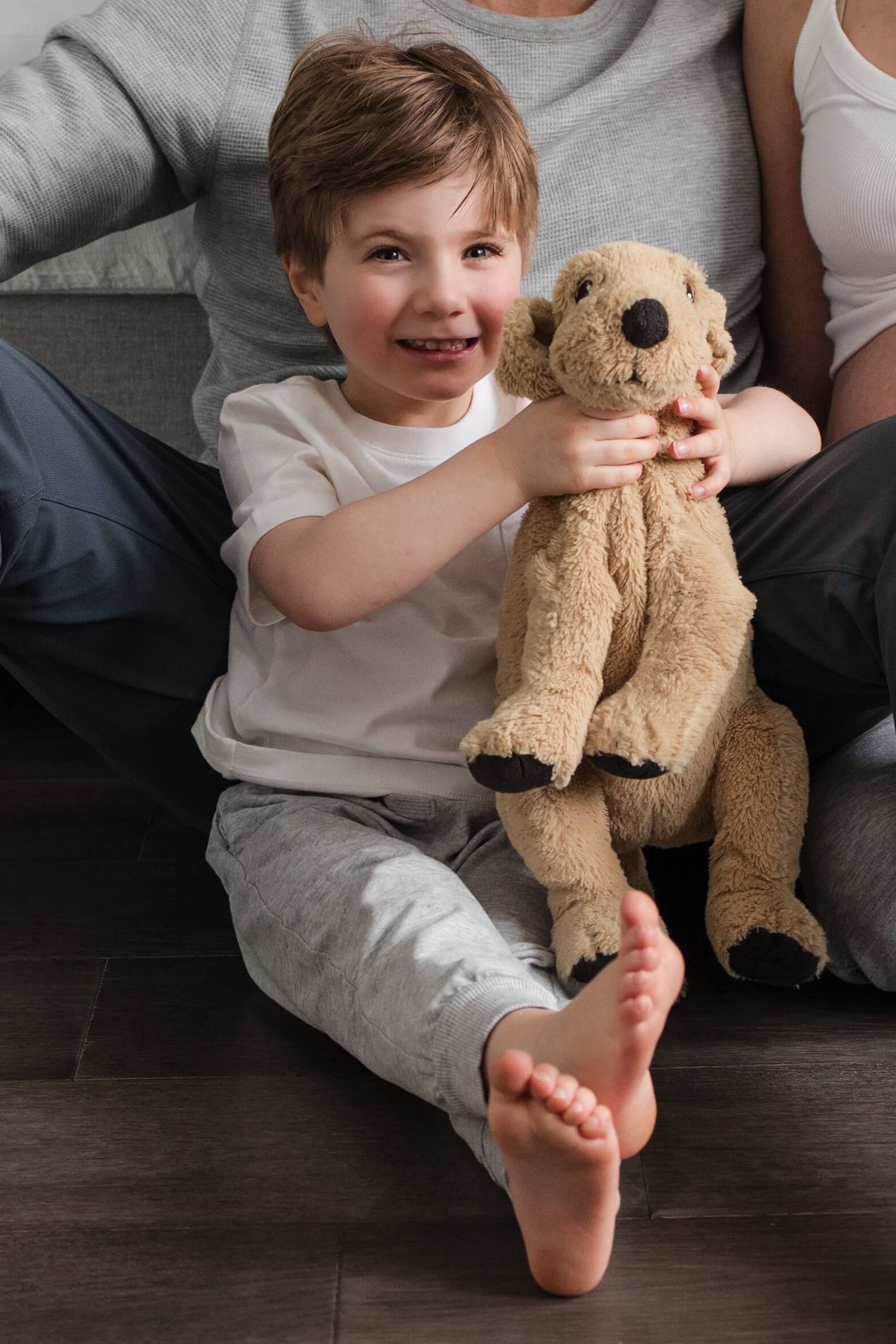 Big brother holding his favourite teddy during an in-home maternity photography session in Toronto, celebrating a growing family.