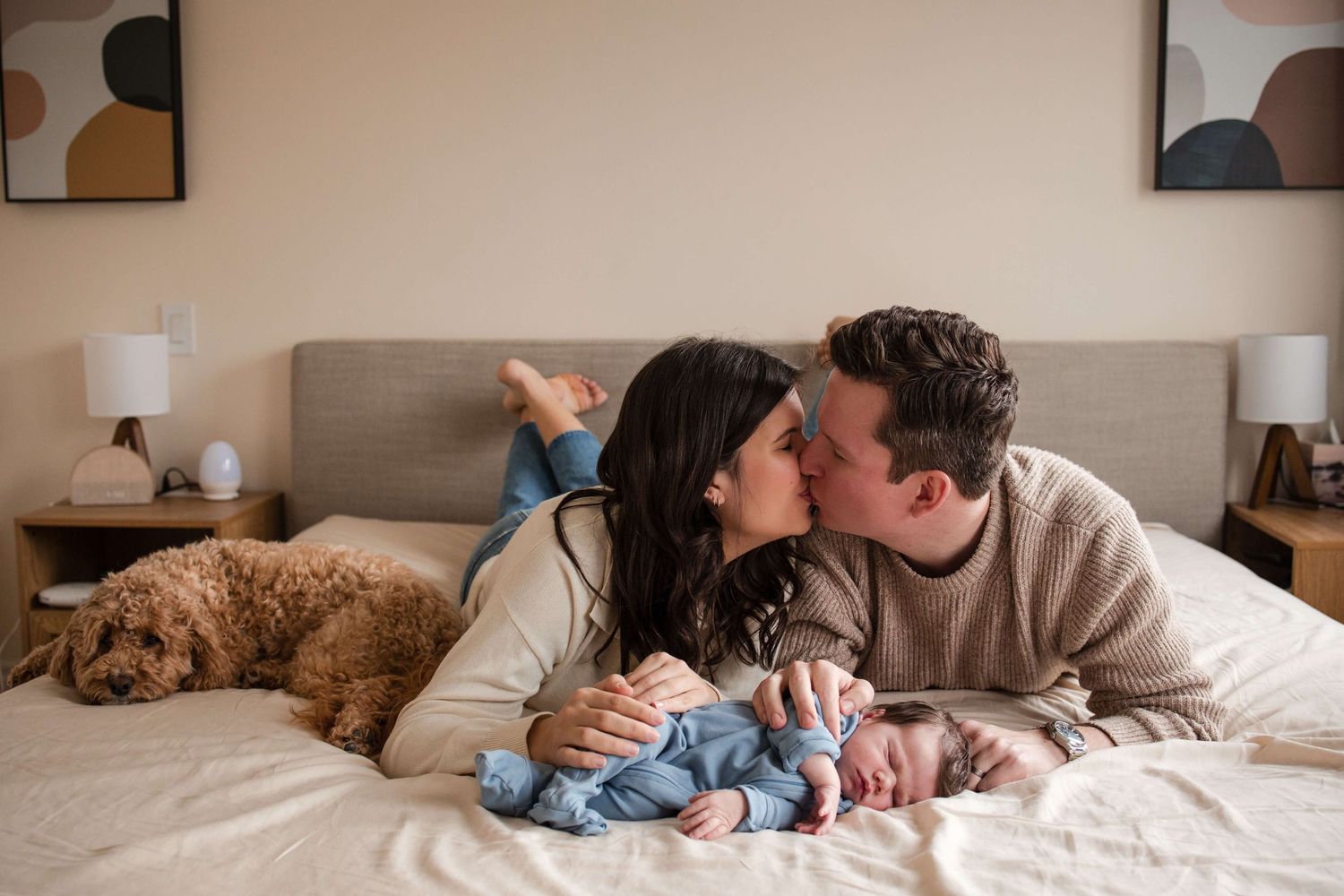 New parents sharing a loving moment with their newborn during a lifestyle newborn session in Toronto.
