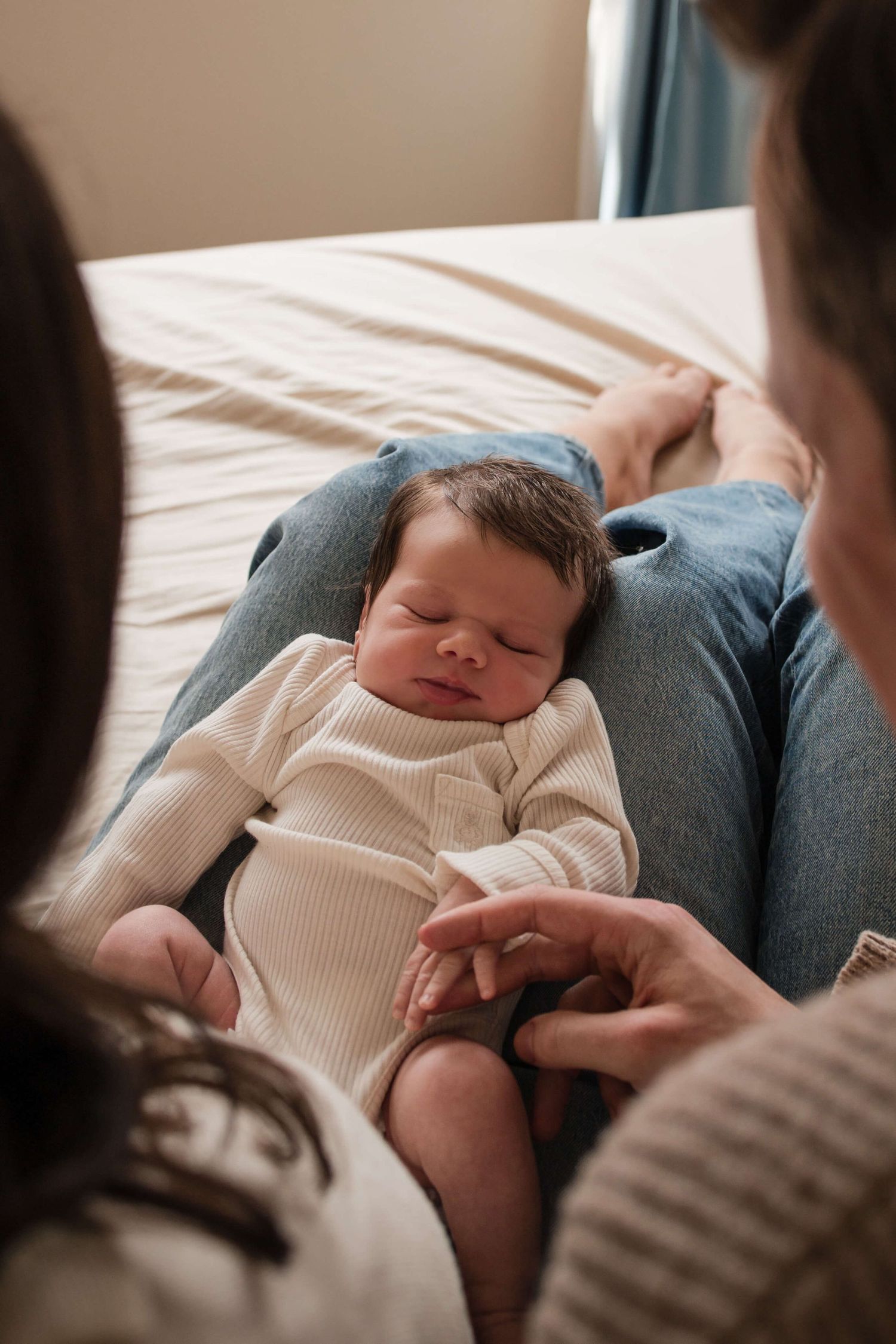 New parents admiring their newborn during a natural lifestyle newborn photography session in Toronto.