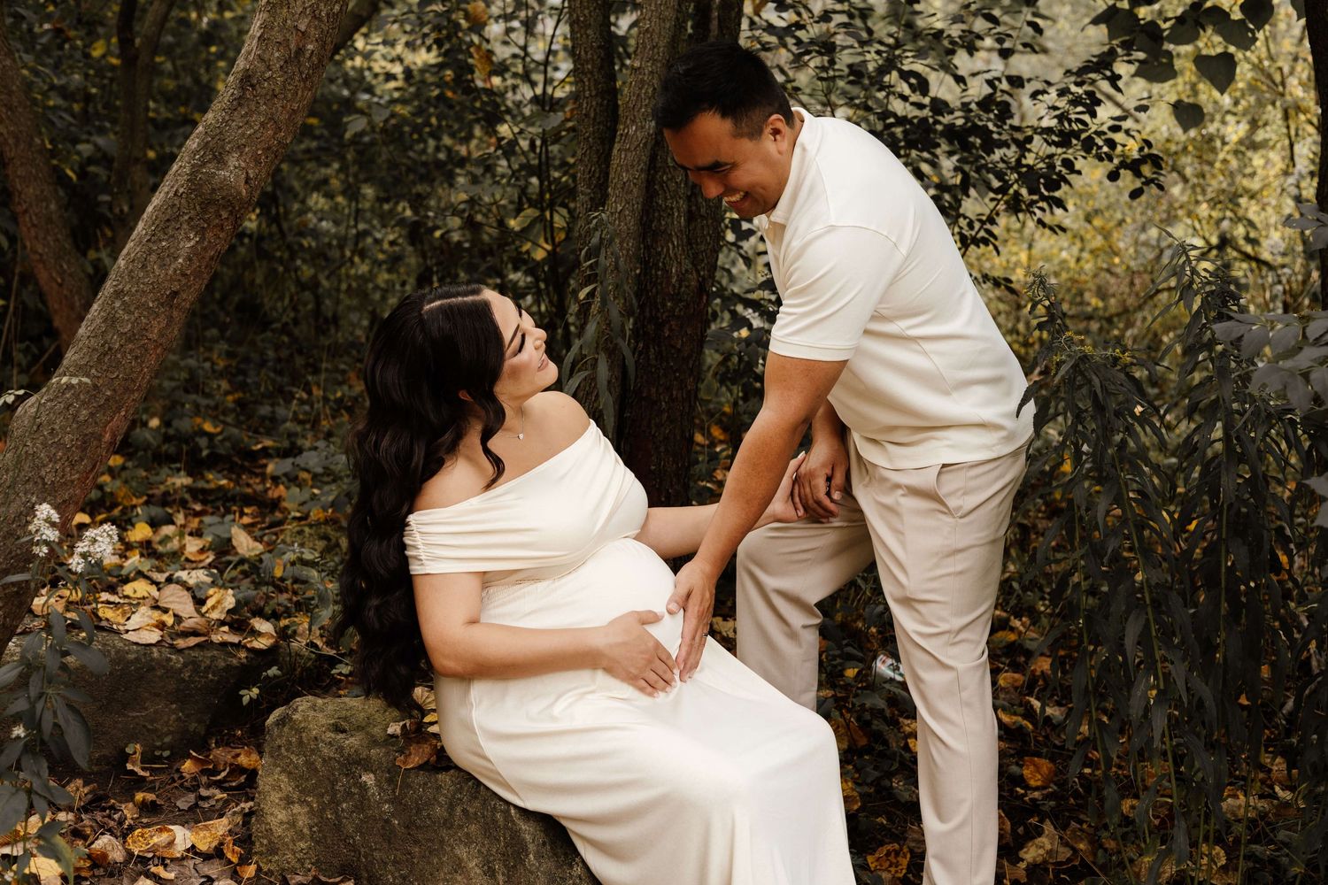 Expectant parents sharing a tender maternity moment at Evergreen Brick Works during an outdoor pregnancy photography session in Toronto.