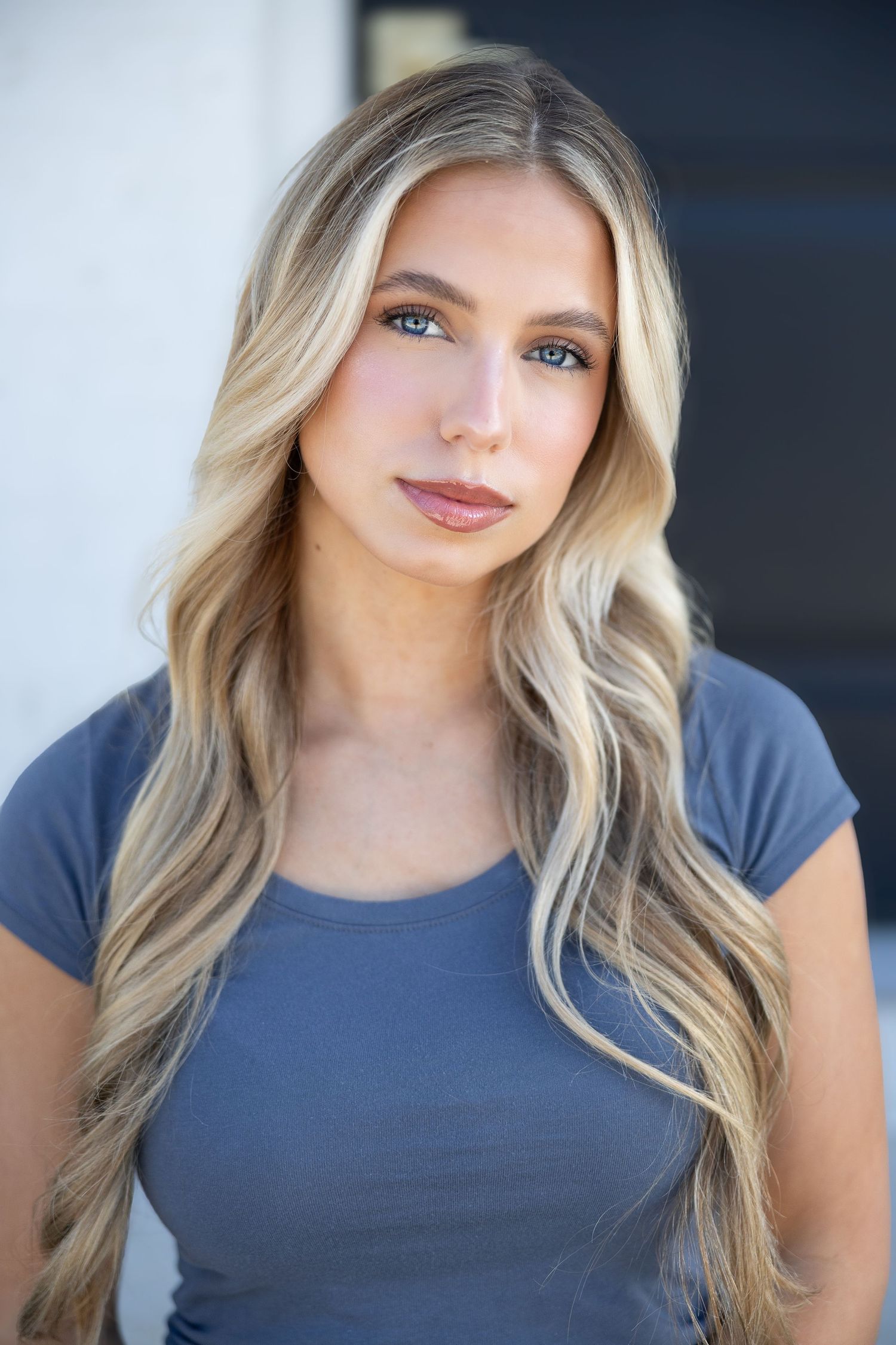 Professional headshot series against dark background with soft lighting.