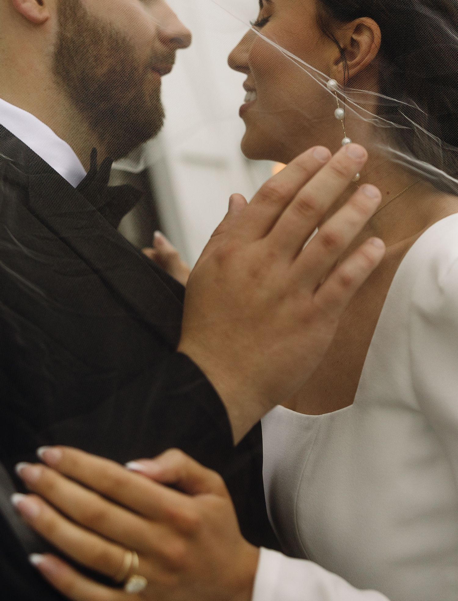 Close-up romantic moments between newlyweds in black and white tones.
