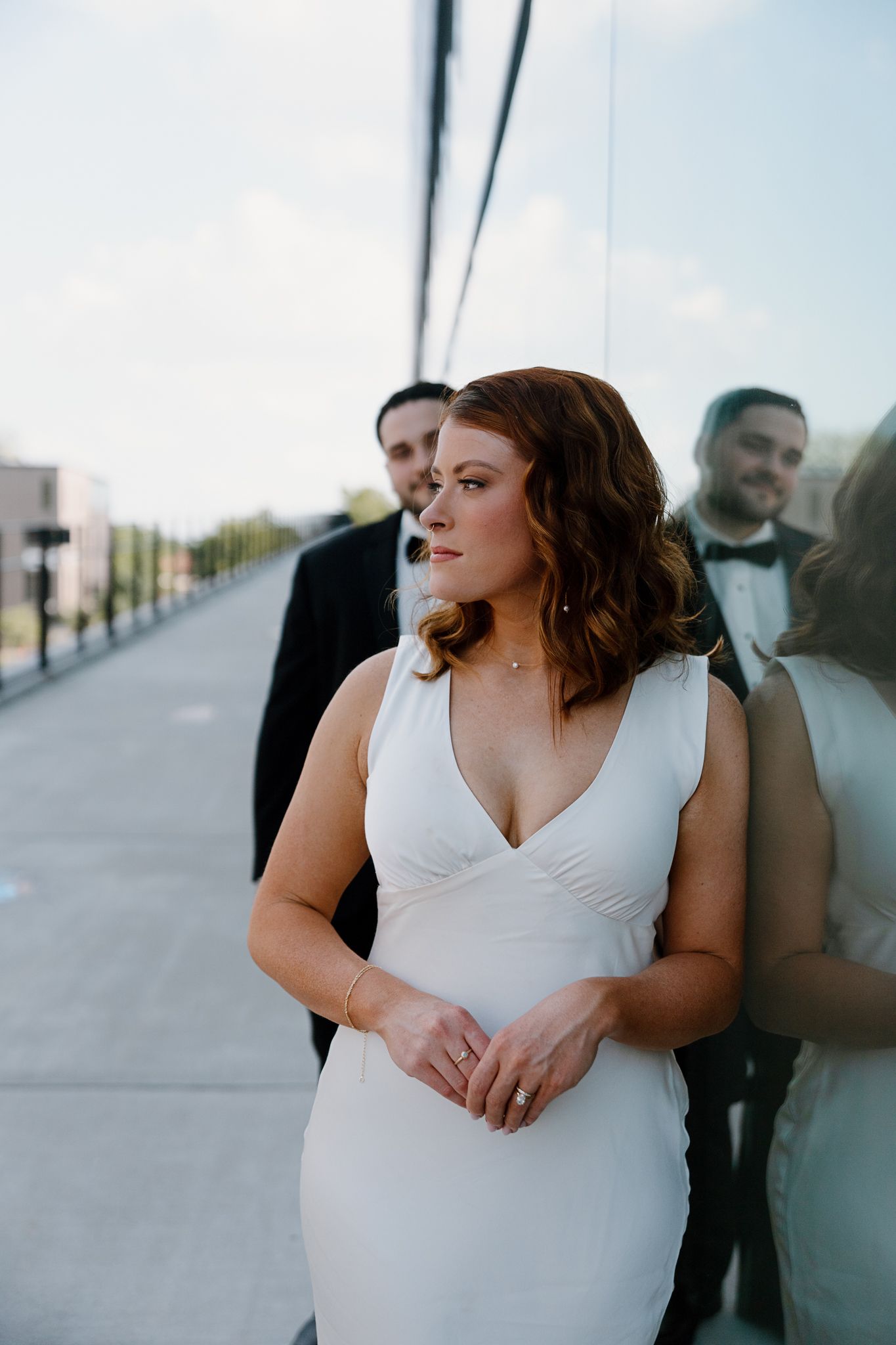 Intimate wedding portraits captured against a modern architectural backdrop.