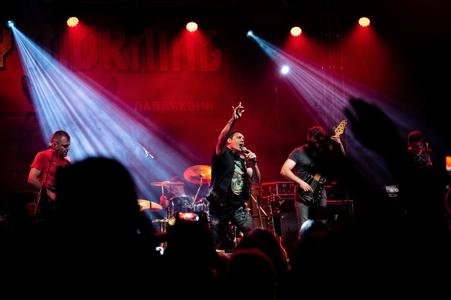 Wide stage view with dramatic lighting and crowd silhouettes, highlighting the scale and atmosphere of the concert in Bulgaria.