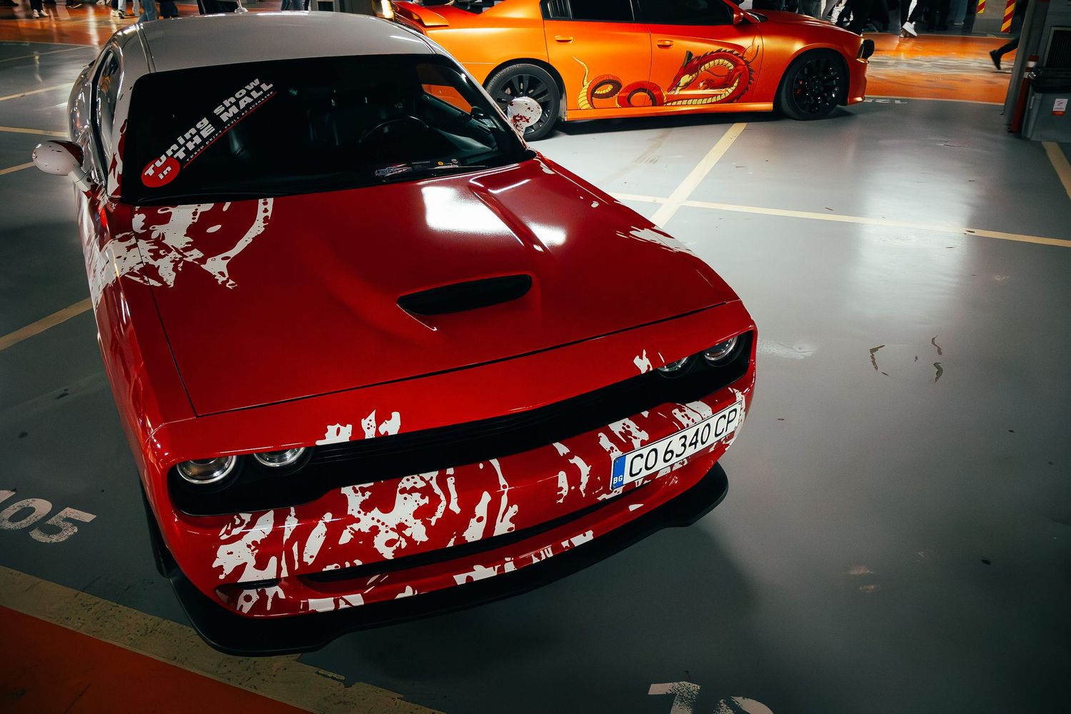 Red Dodge muscle car at indoor tuning event – automotive event photography in Bulgaria.