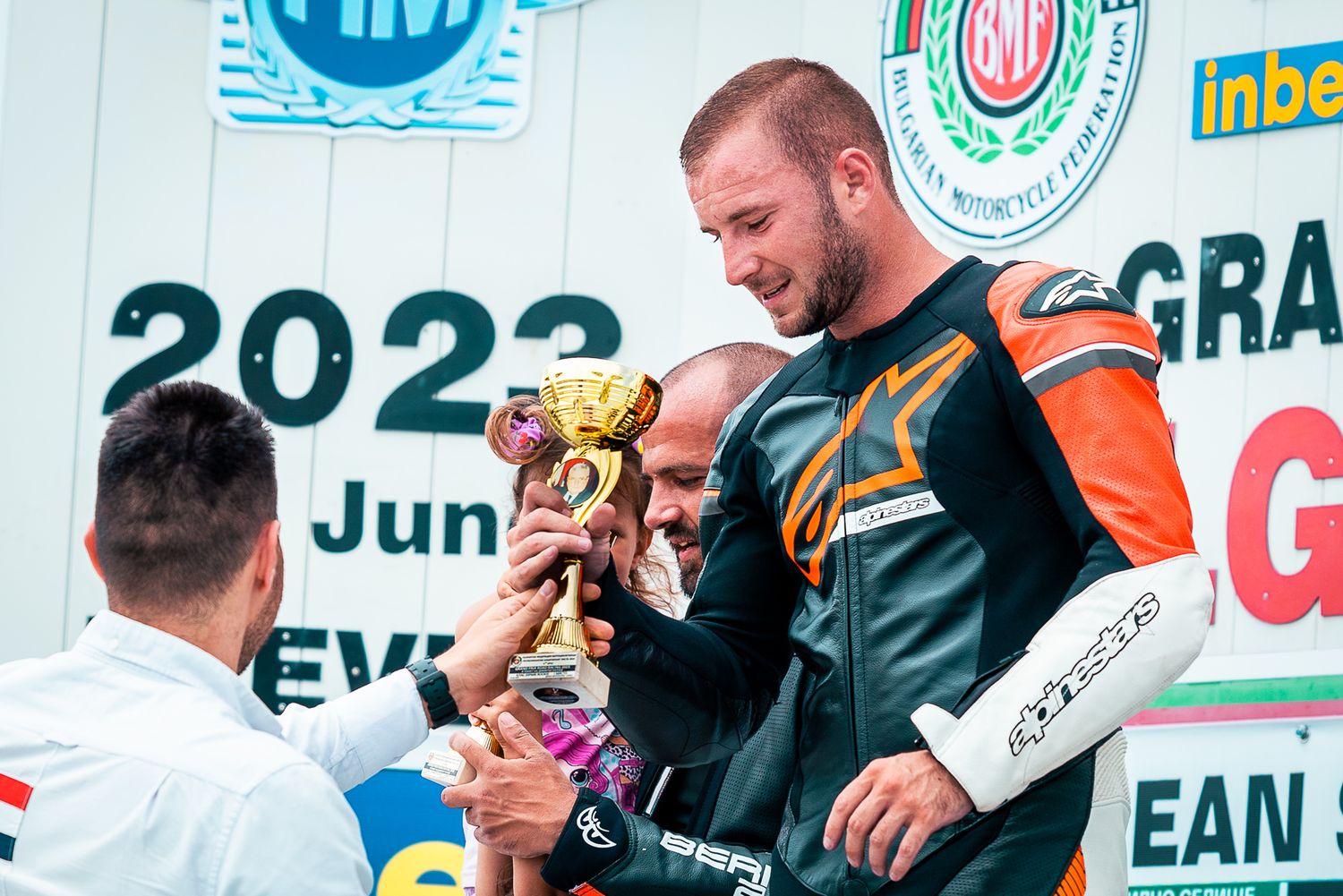 Award presentation on stage, capturing recognition, interaction and formal event structure in Bulgaria.