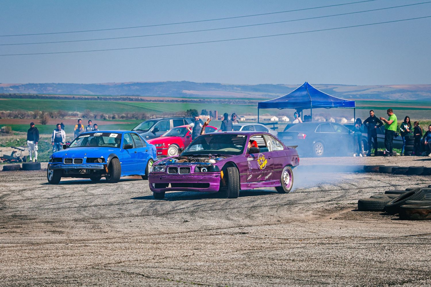 Drift cars in action during motorsport event with tire smoke and spectators – sports photography in Bulgaria.