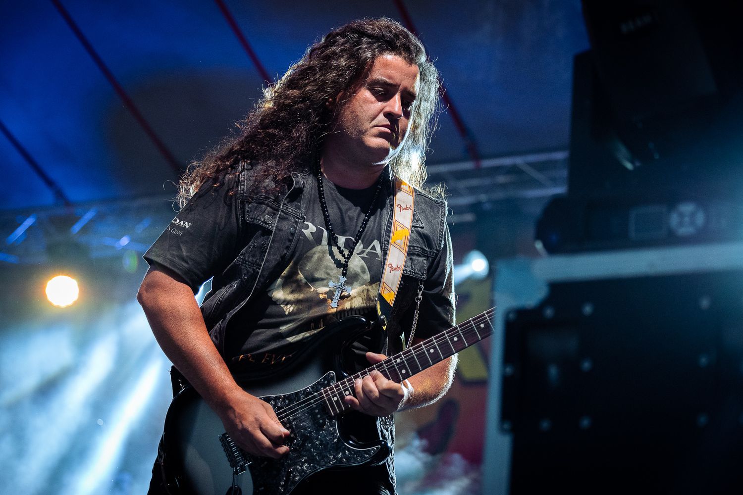 Electric guitar performance captured in dramatic lighting, showcasing intensity and concert atmosphere in Bulgaria.