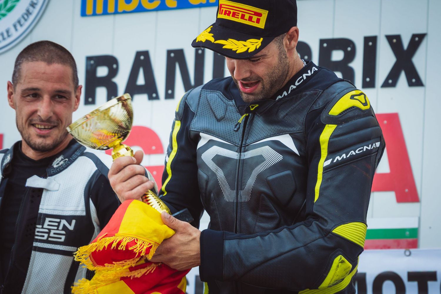 Motorsport riders receiving trophy during podium ceremony – sports photography in Bulgaria.